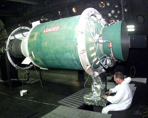 AEDC outside machinist J. R. Dunham prepares a Minuteman Stage III motor before testing in J-6 in 2003. Operators fired the randomly selected motor at a simulated altitude of 100,000 feet to qualify the motor’s production lot. The test confirmed contaminants in the propellant did not impact motor performance.