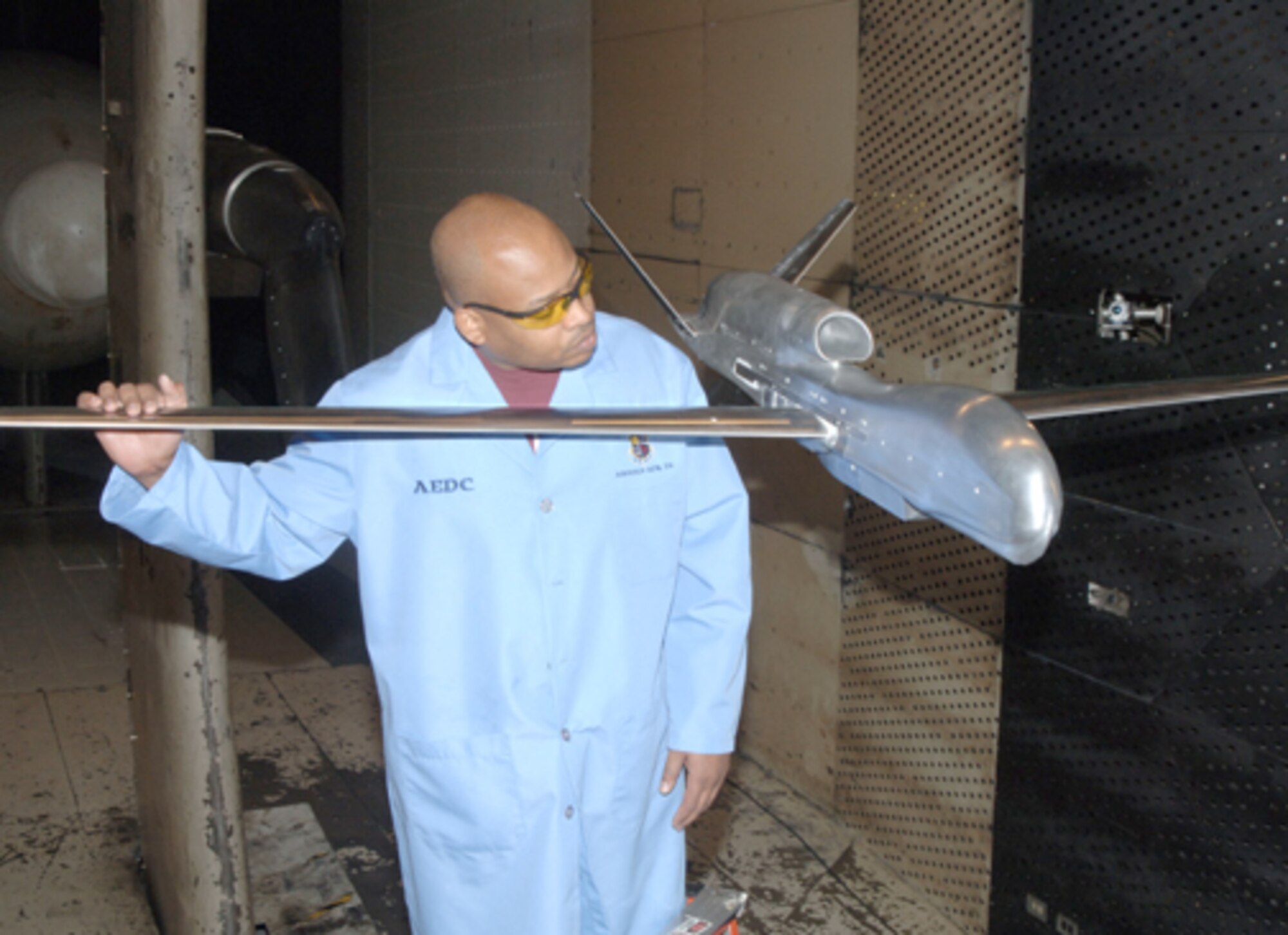 Jeffrey Castleman, ATA outside machinist, inspects the Global Hawk model being used for aerodynamic testing in AEDC’s 16-foot transonic wind tunnel.