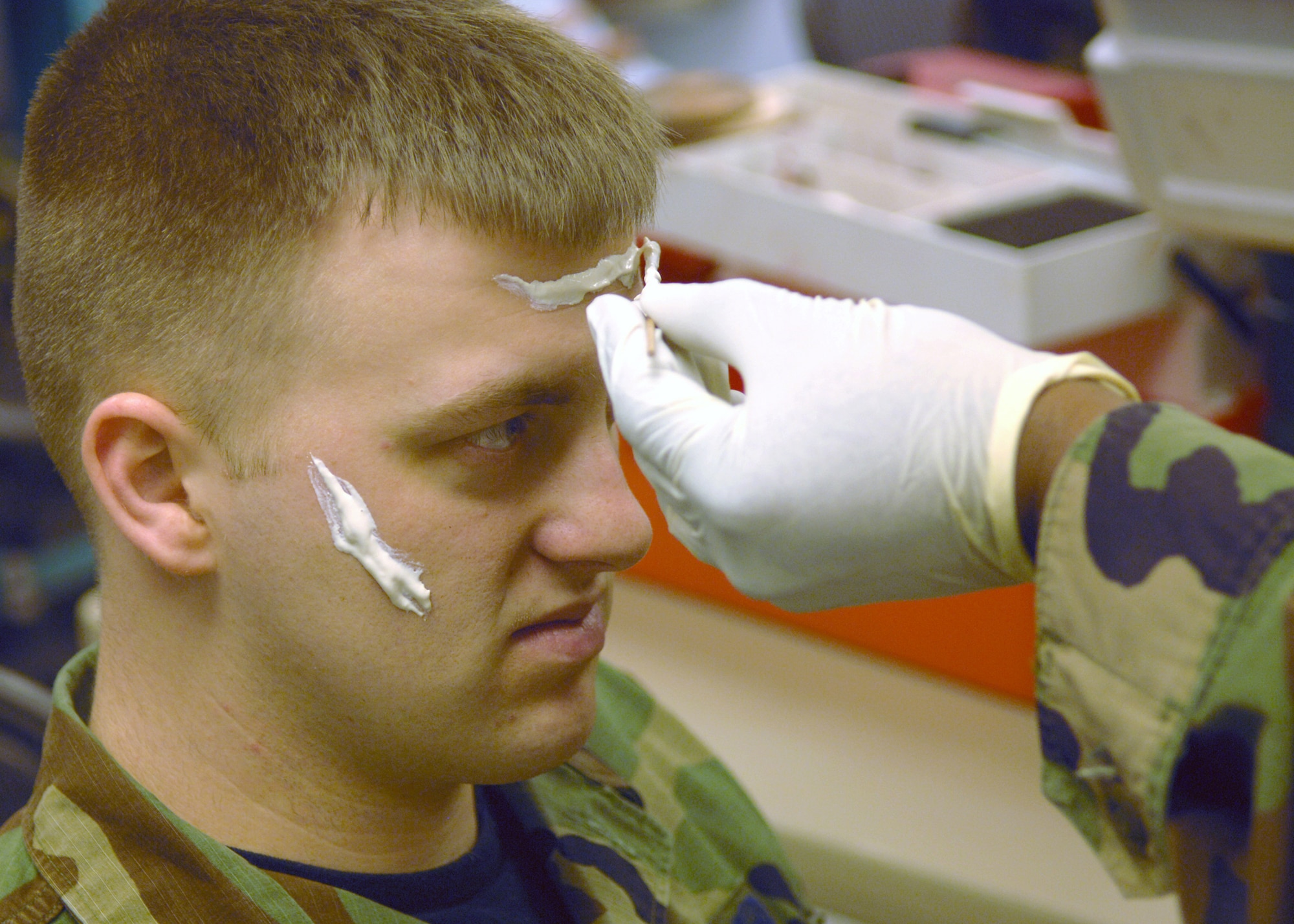 Master Sgt. Jeffery McWaine of the 39th Medical Group applies a moulage to Staff Sgt. Barry Walter of the 39th Mission Support Group, who is playing the part of a casualty, during a wing exercise Feb. 8. This exercises is to prepare Incirlik for an upcoming inspection in April.  (U. S. Air Force Photo by Airman First Class Nathan W. Lipscomb)  
