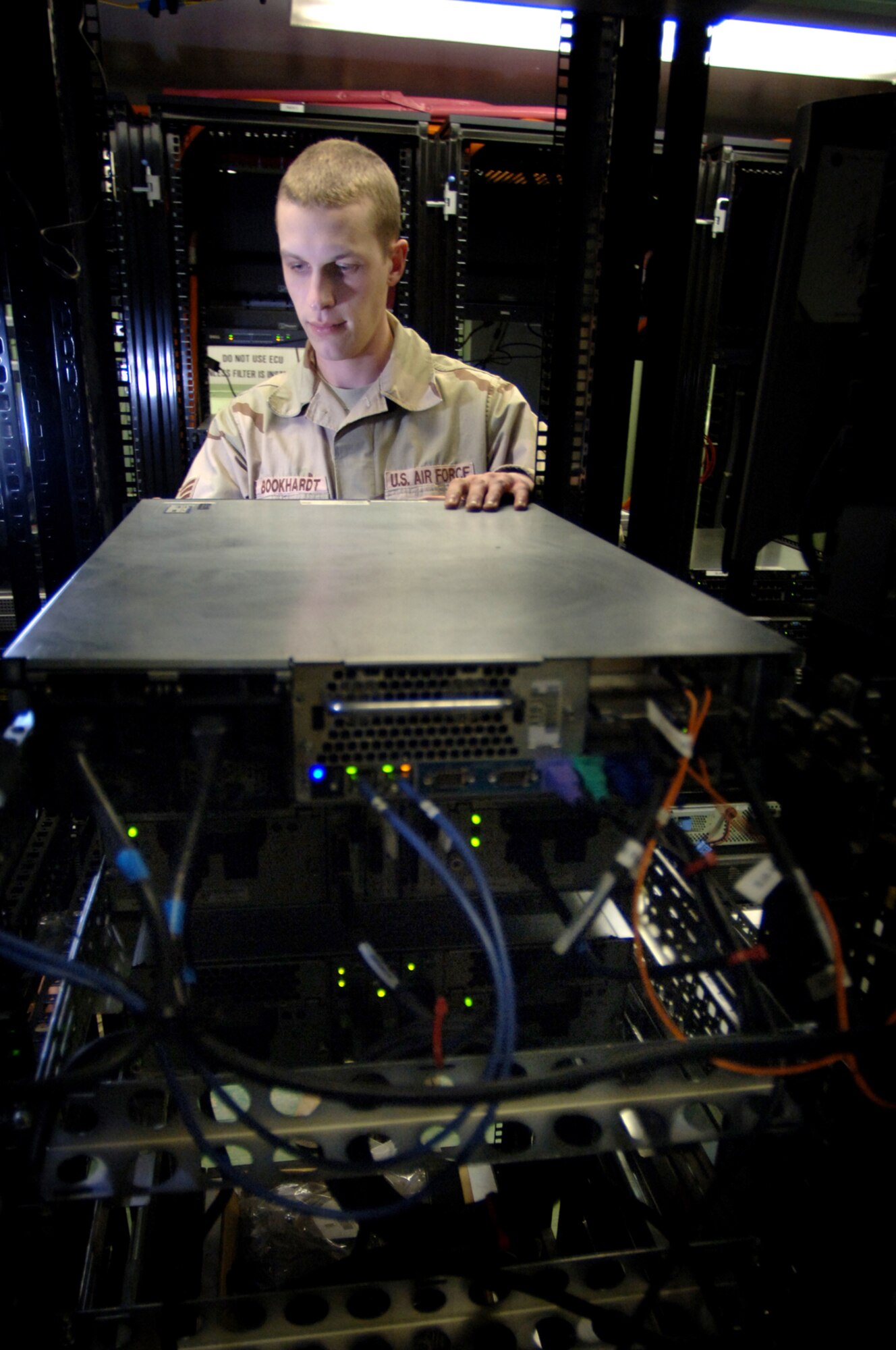 Balad Air Base, Iraq--Staff Sgt. Michael Bookhardt of the 332nd Expeditionary Communications Squadron Network Administration office prepares to remove a server from the network to perfom a Preventative Maintenance Inspection (PMI).  PMI's are done periodically to help the network stay up and running at Balad Air Base.  (U. S. Air Force photo/Staff Sgt. Michael R. Holzworth) (Released) 