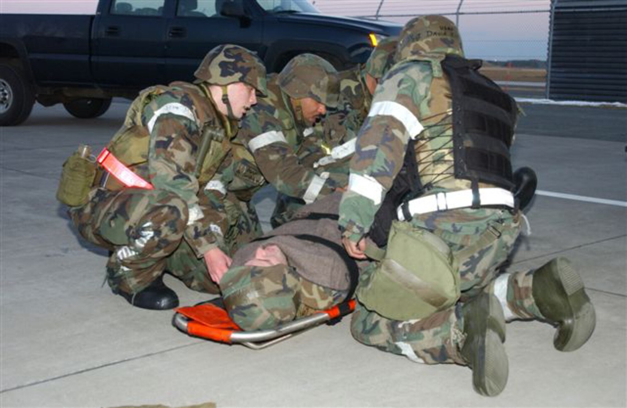 070209-F-5751H-012 MISAWA AIR BASE JAPAN --  Airman First Class Noah Kelley, 35th Logistics Readiness Squadron, is prepared for transport by fellow airmen after a simulated accident where he crashed into a fuel stand and fractured his arm here during Operational Readiness Exercise Feb. 9. Airman Kelley's injury is simulated to test the readiness of the personnel on Misawa during the exercise. (U.S. Air Force photo by Airman 1st Class Eric Harris) 
