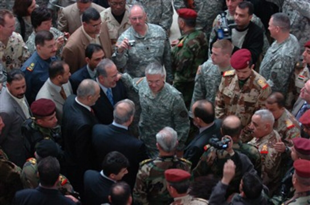 U.S. Army Gen. George W. Casey Jr., center, speaks to the crowd following the Multi-National Force - Iraq change of command ceremony at Camp Victory, Iraq, Feb. 10, 2007. During the ceremony, Casey relinquished command to Army Gen. David H. Petraeus.