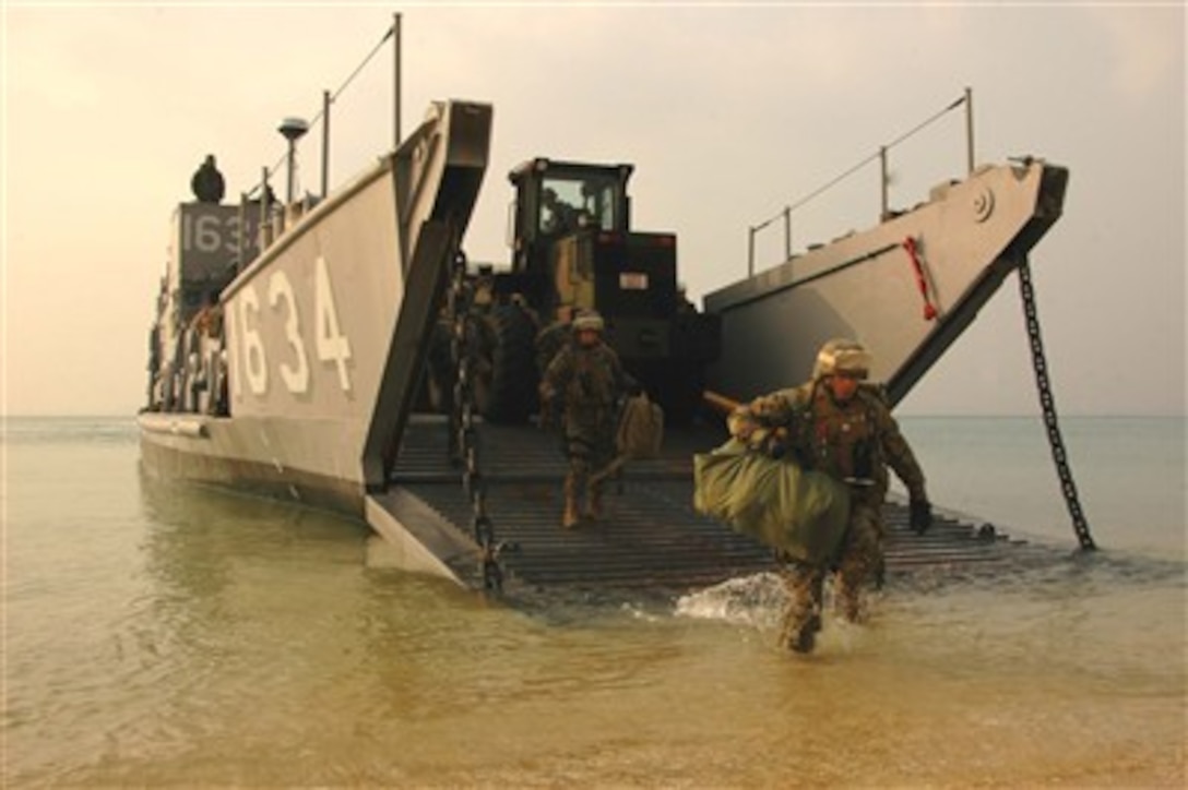 U.S. Marines from the 31st Marine Expeditionary Unit wade ashore at the Kin Blue Beach Training Area in Okinawa, Japan, on Feb. 11, 2007.  The Marines are participating in an on-load and offload exercise while under way for spring patrol with amphibious assault ship USS Essex (LHD 2).  
