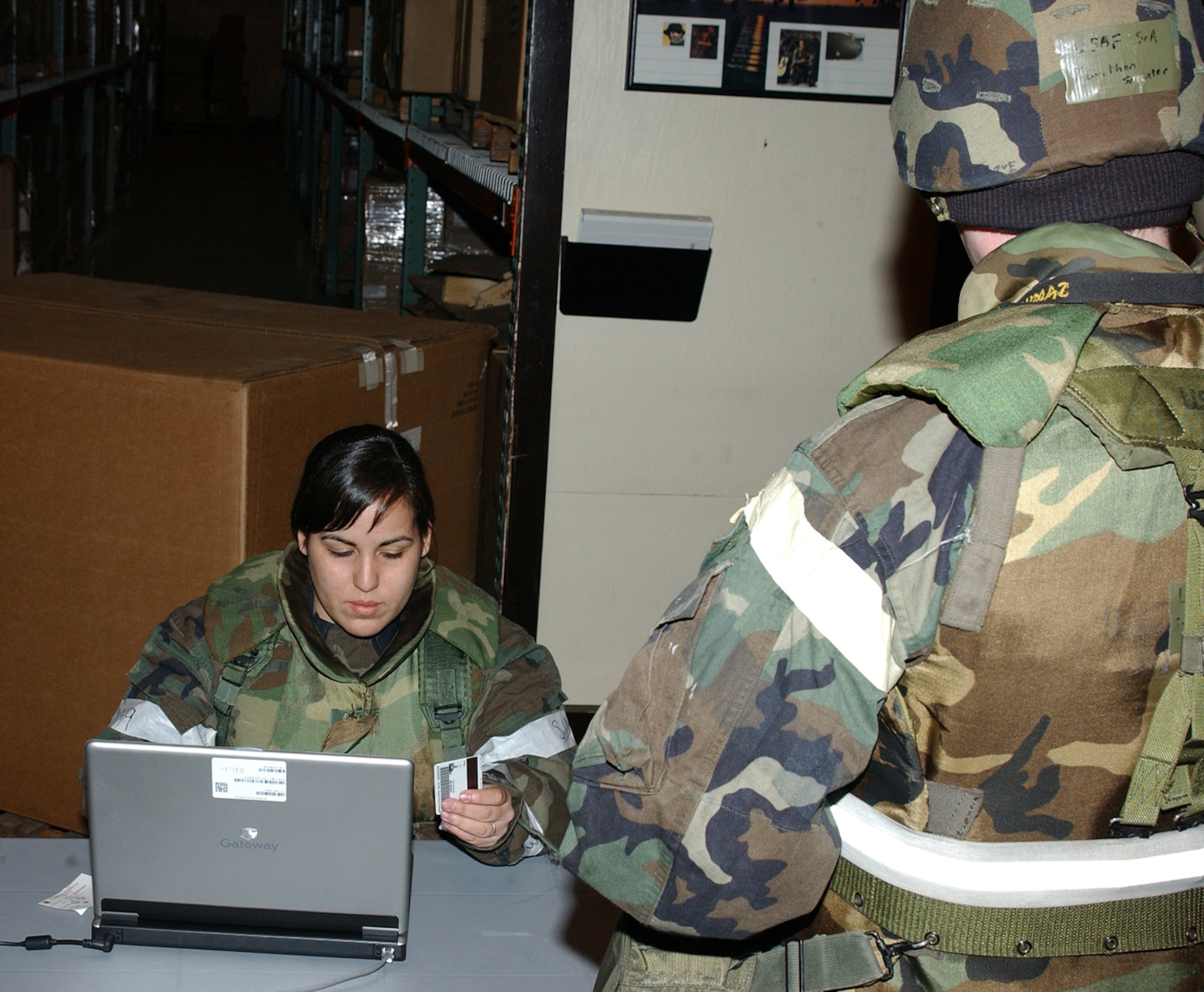 02/10/2007- MISAWA AIR BASE JAPAN -- Second Lieutenant Joni Aevermann, 35th Mission Support Squadron, processes Senior Airman Johnathan Schlieter, 35th Aircraft Maintenance Squadron, through the transition area during Misawa's Operational Readiness Exercise Beverly Sunrise 07-05 Feb. 10. TAs are used to track active participants in the ORE. (U.S. Air Force photo by Airman 1st Class Eric Harris)