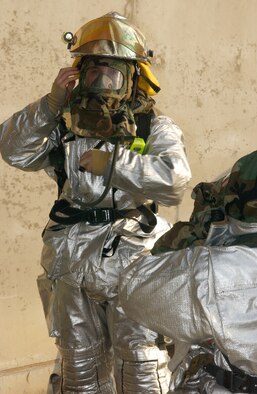 02/10/2207 - ISAWA AIR BASE JAPAN --  Misawa Air Base Firefighters from the 35th Civil Engineer Squadron don their equipment in preparation to fight a simulated fire during the Operational Readiness Exercise Beverly Sunrise 07-05 Feb. 10 here. (U.S. Air Force photo by Airman 1st Class Eric Harris) 