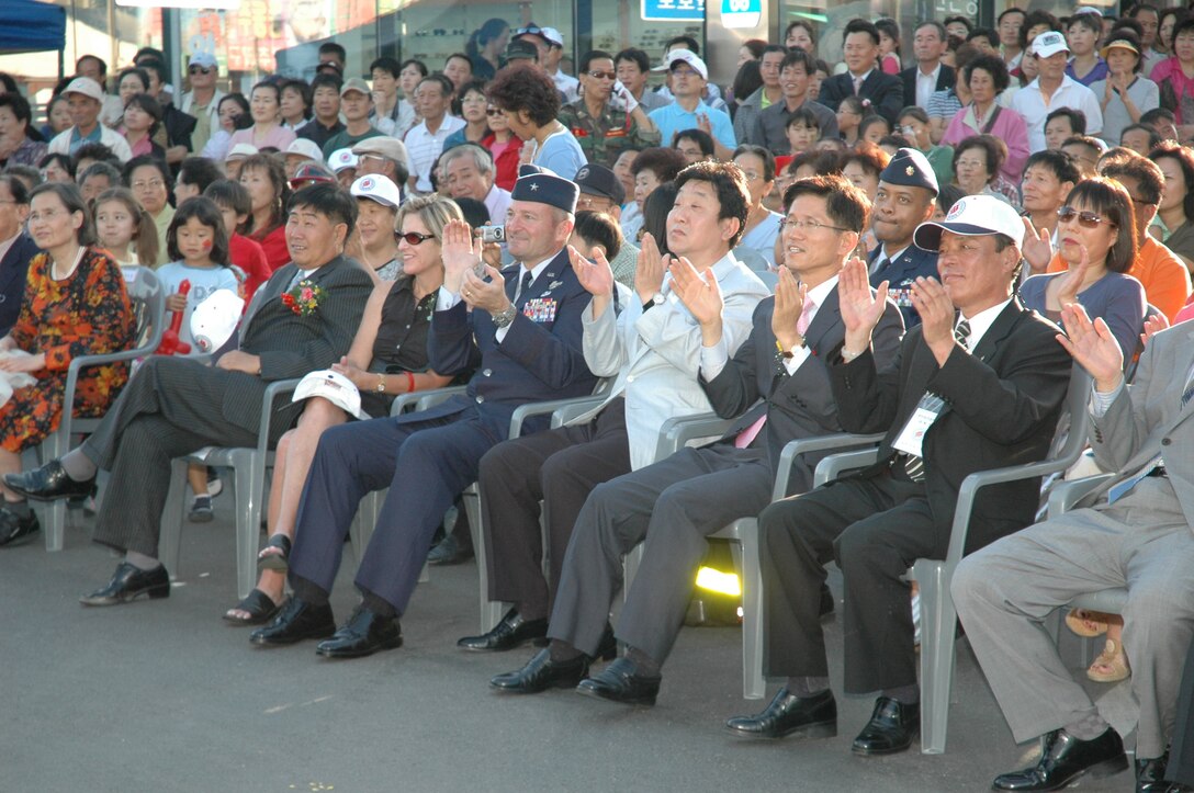 SONGTAN, Republic of Korea --  Brig. Gen. Joseph Reynes, 51st Fighter Wing commander, and his wife, Karen, enjoy a show from Korean pop star In Soon Ni following the opening ceremonies Saturday. Also in attendance from Gyeonggi Province were Governor Kim, Moon Soo, Vice Governor Won, Congressman Chung, Congressman Woo, Songtan Mayor Song, Myong-Ho, Songtan City Council Chairman Bae, Yon So and Songtan Chamber of Commerce President Kasey Lee. (U.S. Air Force photo by Tech. Sgt. Michael O'Connor)
