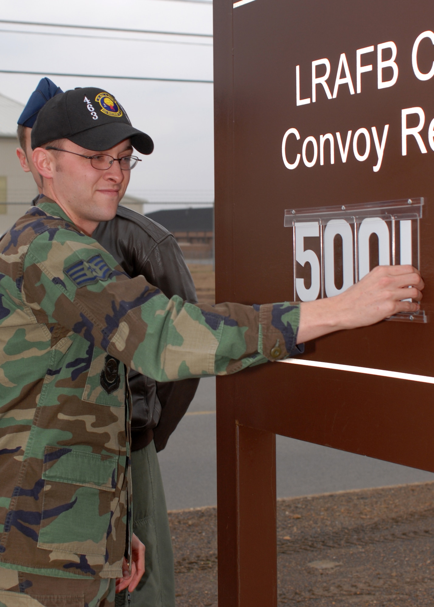 LITTLE ROCK AIR FORCE BASE, Ark. -- Staff Sgt. Jason Daldrup, 463rd Maintenance Operations Squadron, changes the 463rd Airlift Group's Convoy Reduction in Iraq total sign to 5001 Feb. 13. The sign tallies the number of buses and trucks the Herculean power of C-130 tactical airlft keeps off the roads of Iraq. (U.S. AIr Force photo by Airman 1st Class Christine Clark)