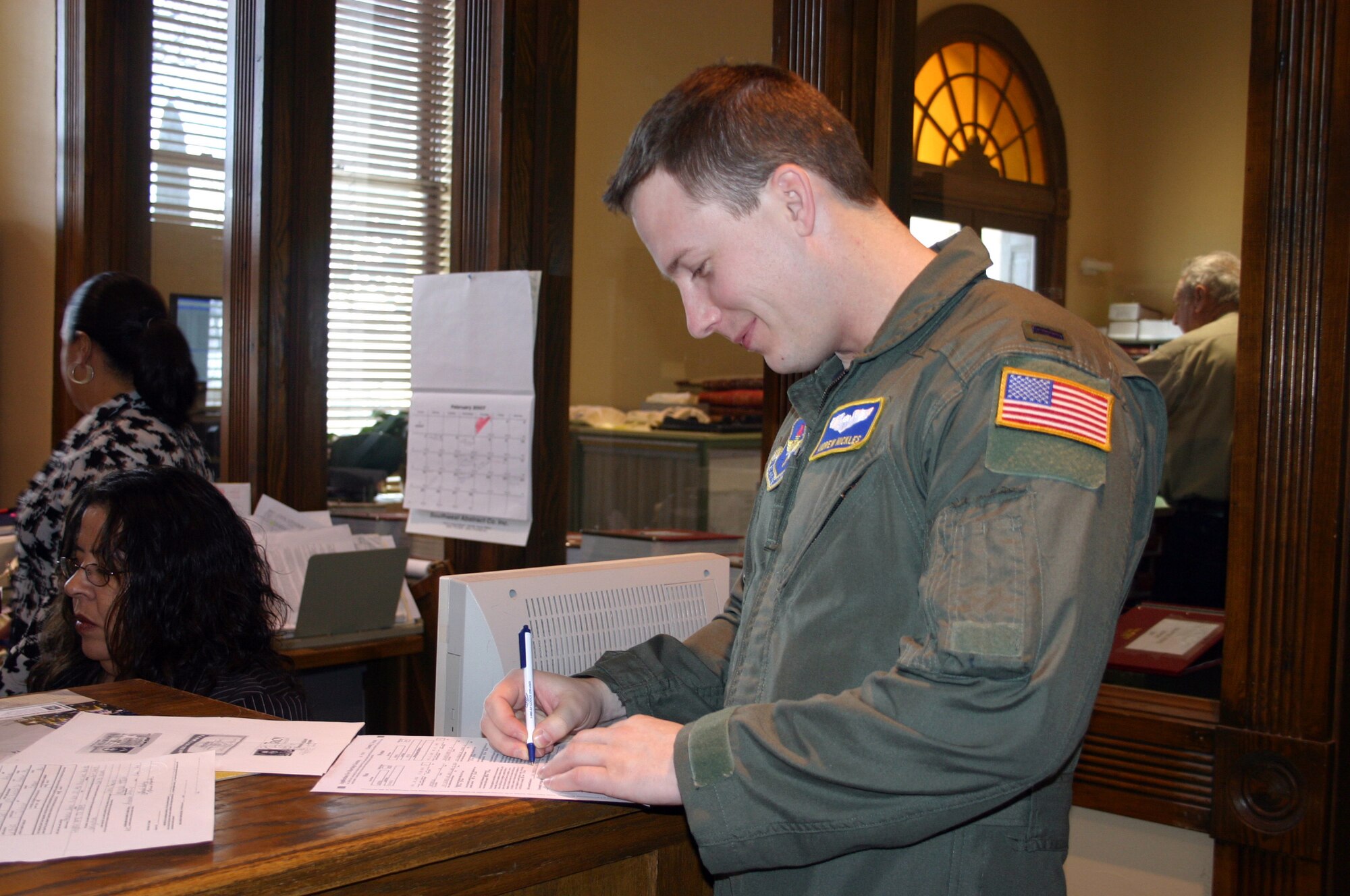 LAUGHLIN AIR FORCE BASE, Texas -- Moments before saying his vows over the phone, 1st Lt. Andrew Nickles signs the required paperwork for marriage by proxy.  (U.S. Air Force photo by 2nd Lt. Courtney L. Kippenberger)   