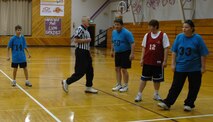 MINOT, N.D. – Master Sgt. Clayton Lowry, 5th Operations Support Squadron, referees a game during the Minot Special Olympics district basketball tournament at Bishop Ryan High School Feb. 10. He and almost 20 other members from the base community provided all the volunteer support for the tournament. (U.S. Air Force photo by Maj. Elizabeth Ortiz)