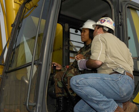 SHAW AIR FORCE BASE, S.C. -- Lt. Col. Jacqueline Crum, 20th Civil Engineer Squadron commander, gets instruction from John Yannuzzi, crane operator, on how to operate the crane used to demolish the Aim High building, a Shaw-Sumter landmark, Dec. 18, 2006. Colonel Crum says her heritage played a large role in her upbringing and the leadership characteristics she brings to her squadron. (U.S. Air Force photo/ Airman 1st Class William Coleman)