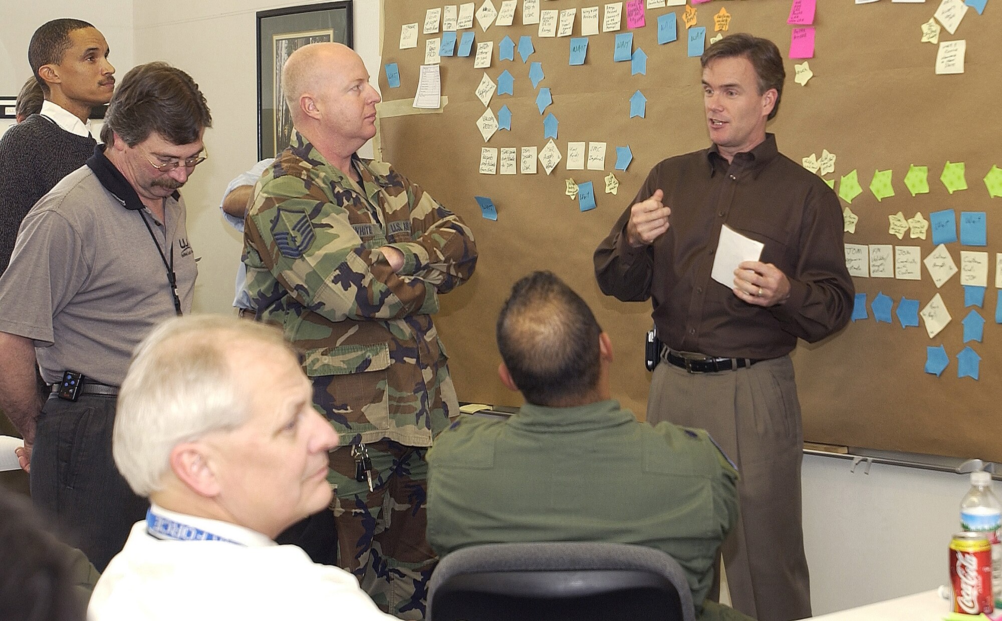 David Ballard, facilitator of the Air Force Smart Operations for the 21st Century, team 1, discusses with contractors, civilians, and military personnel the values and necessity of each missile launch on Jan. 30 at Vandenberg.  AFSO21 was separated into three teams according to Vandenberg's mission concerning the 2nd Range Operations Squadron here.  All the teams worked together to process a more efficient and less expensive launch. (U.S. Air Force photo by Airman 1st Class Ashley Tyler)