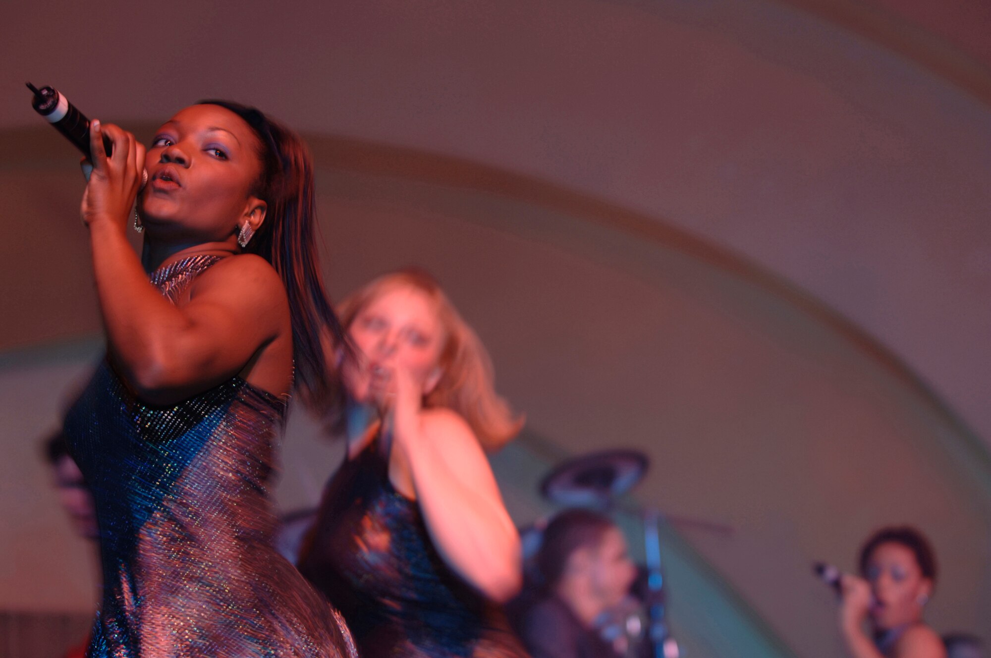 Staff Sgt. Bethany Anderson-Burrs performs a song during the Tops In Blue concert at the Cotillion Ballroom in Wichita, Kan. Jan. 31. Members of McConnell Air Force Base and the surrounding community enjoyed the free show despite cold weather conditions. Tops In Blue perform in various locations including hostile locations for deployed members. (Air Force photo by Senior Airman Jamie Train, 22nd Communications Squadron) 