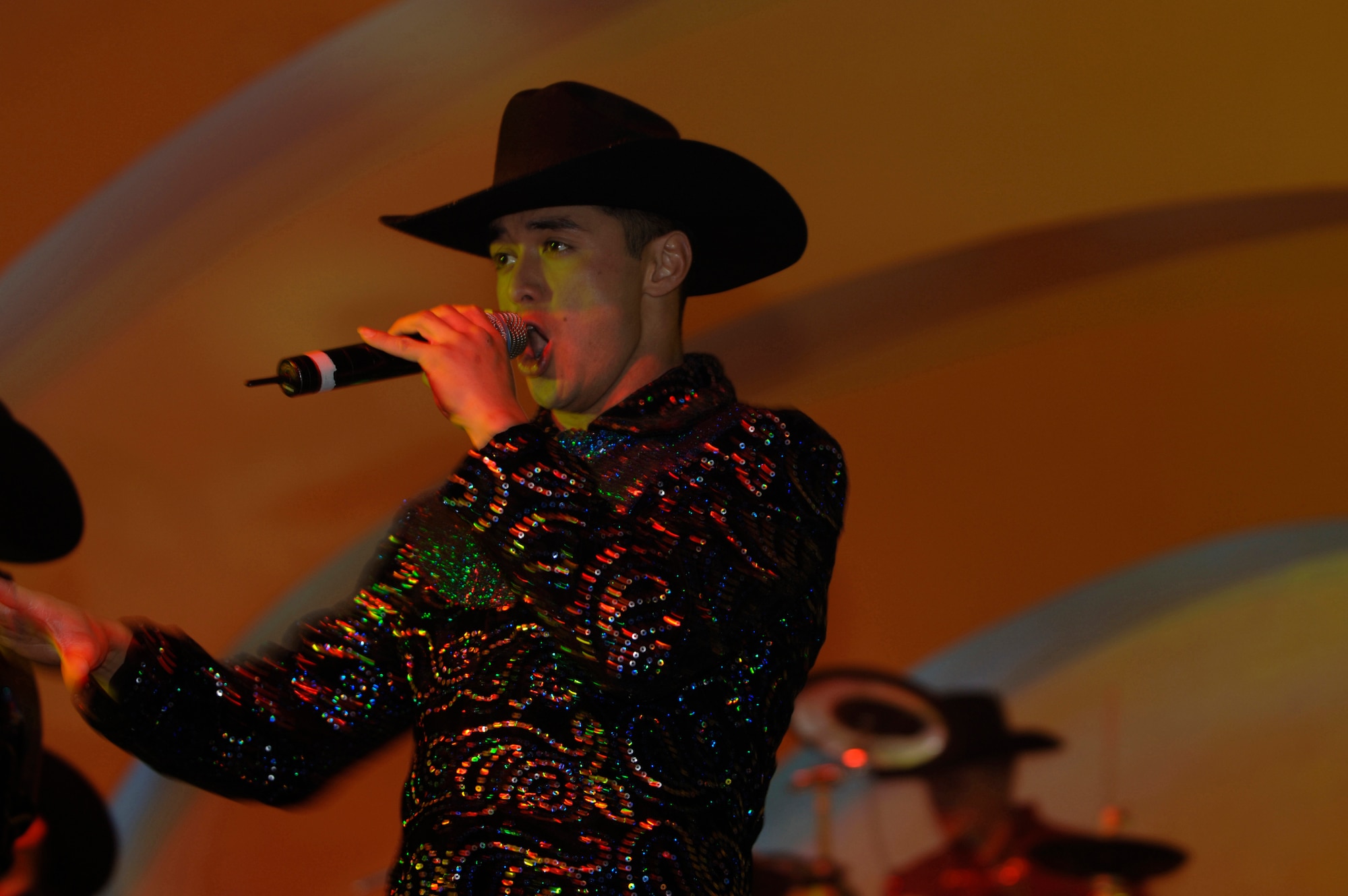 Senior Airman Shiloh Pogue performs a song during the 2006 Tops In Blue world tour at the Cotillion Ballroom in Wichita, Kan. Jan. 31. Members of McConnell Air Force Base and the surrounding community enjoyed the free show despite cold weather conditions. Tops In Blue perform in various locations including hostile locations for deployed members. (Air Force photo by Senior Airman Jamie Train, 22nd Communications Squadron) 