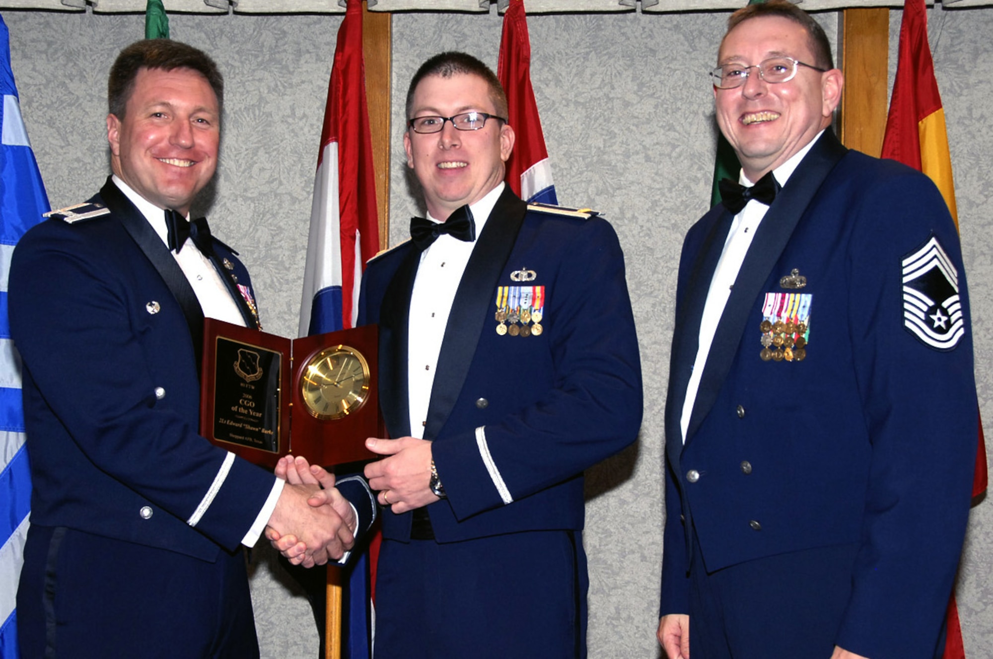 Second Lt. Shawn Burke is the 80th Flying Training Wing's 2006 Company Grade Officer of the Year. Lieutenant Burke set himself apart during his deployment to Mosul. The 80th Operations Group officer's abilities as a weather officer ensured weather forecasts were precise to enable the mission to continue. He also updated forecast reference notebooks. Back home, Lieutenant Burke was key in the planning stages of moving the weather section into its new home at the Airfield Operations Complex. He served as treasurer for Sheppard's Company Grade Officer Council and taught literature and folklore to a local Boy Scout Troop. Also pictured, left, 80th FTW Commander Jeffrey Kendall and Chief Master Sgt. Norman Thierolf, 80th FTW superintendent. (U.S. Air Force photo/Harry Tonemah)