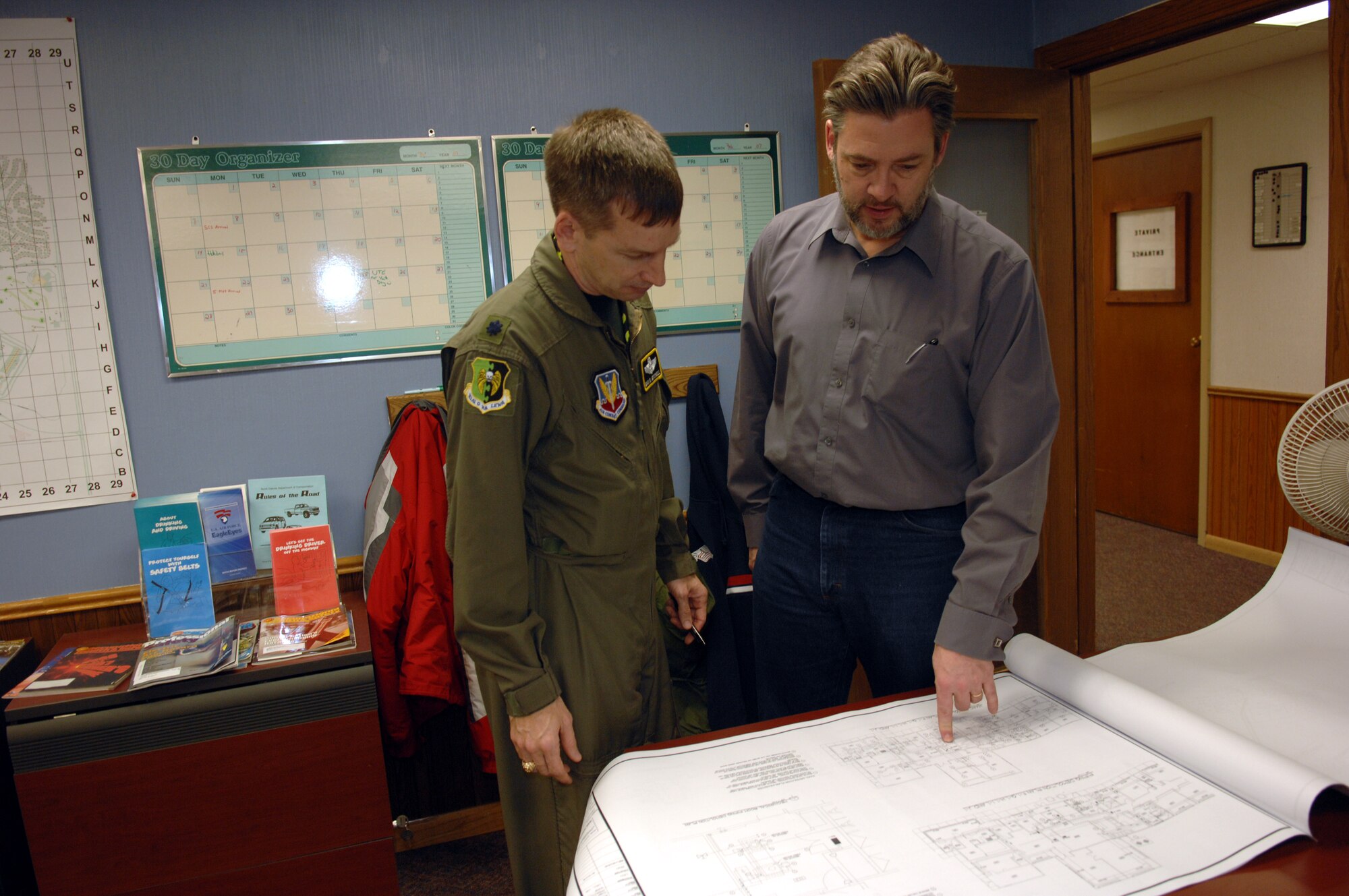 MINOT AIR FORCE BASE, N.D. – Lt. Col. Max Mitchell, 5th Bomb Wing chief of safety, and Dan Heald, 5th Bomb Wing Safety Office, look over floor plans of the PRIDE Building to ensure safety precautions are met. Mr. Heald recently won the 2006 Air Combat Command Services Ground Safety Award for Distinction. Other 2006 ACC accolades awarded to the 5th Bomb Wing were the Chief of Safety Outstanding Achievement Award for Ground Safety – Category I, a flight safety plaque and a nuclear surety plaque. (U.S. Air Force photo by Airman 1st Class Cassandra Butler)