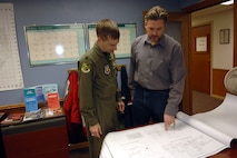 MINOT AIR FORCE BASE, N.D. – Lt. Col. Max Mitchell, 5th Bomb Wing chief of safety, and Dan Heald, 5th Bomb Wing Safety Office, look over floor plans of the PRIDE Building to ensure safety precautions are met. Mr. Heald recently won the 2006 Air Combat Command Services Ground Safety Award for Distinction. Other 2006 ACC accolades awarded to the 5th Bomb Wing were the Chief of Safety Outstanding Achievement Award for Ground Safety – Category I, a flight safety plaque and a nuclear surety plaque. (U.S. Air Force photo by Airman 1st Class Cassandra Butler)
