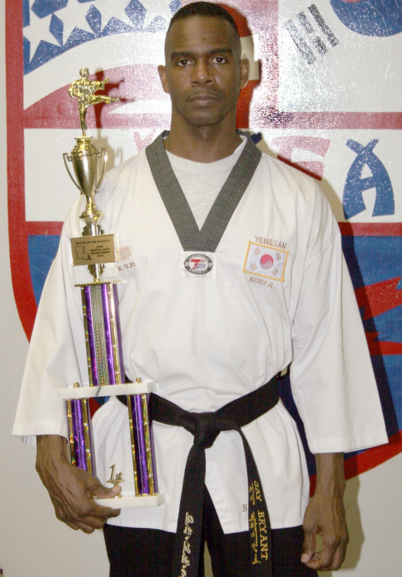 Master Sgt. Jay "Byrd" Bryant, 314th Airlift Wing Public Affairs Superintendent, poses with his first place trophy from The Battle of the Bayou Martial Arts Karate Championships in Shreveport, La., Feb 3. Bryant placed first in the men's over-40 free sparring, black belt division. "I was definitely in shock and completely in awe," said a smiling Master Sgt. Jay "Byrd" Bryant, 314th Airlift Wing Public Affairs Superintendent. Bryant placed first in the men's over-40 free sparring, black belt division. "This was my first competition in 18 years and my first as a black belt," Sergeant Bryant said. "I've been in and out of martial arts for the past four or five years, but during my tour in Seoul, Korea last year, I decided to get serious with it and starting training really hard. Needless to say, I was a bit skeptical of doing well, but after stepping onto that floor and hearing my friends and teammates cheer me on, I was good to go." (Courtesy photo)