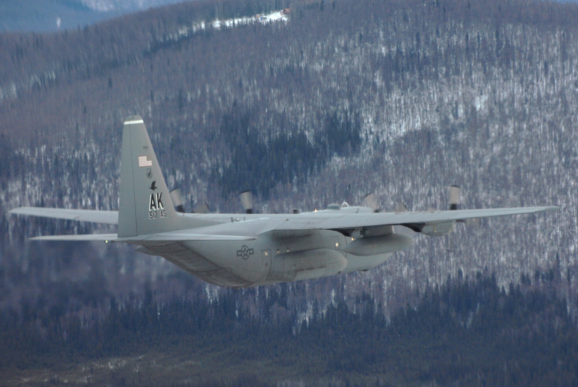 A C-130 Hercules flys a training mission over Alaska Feb. 1. The C-130 belongs to the 517th Airlift Squadron at Elmendorf Air Force Base, Alaska. The 517th AS will replace its fleet of C-130s with the C-17 Globemaster III in 2007. (U.S. Air Force photo/Tech. Sgt. Keith Brown)
