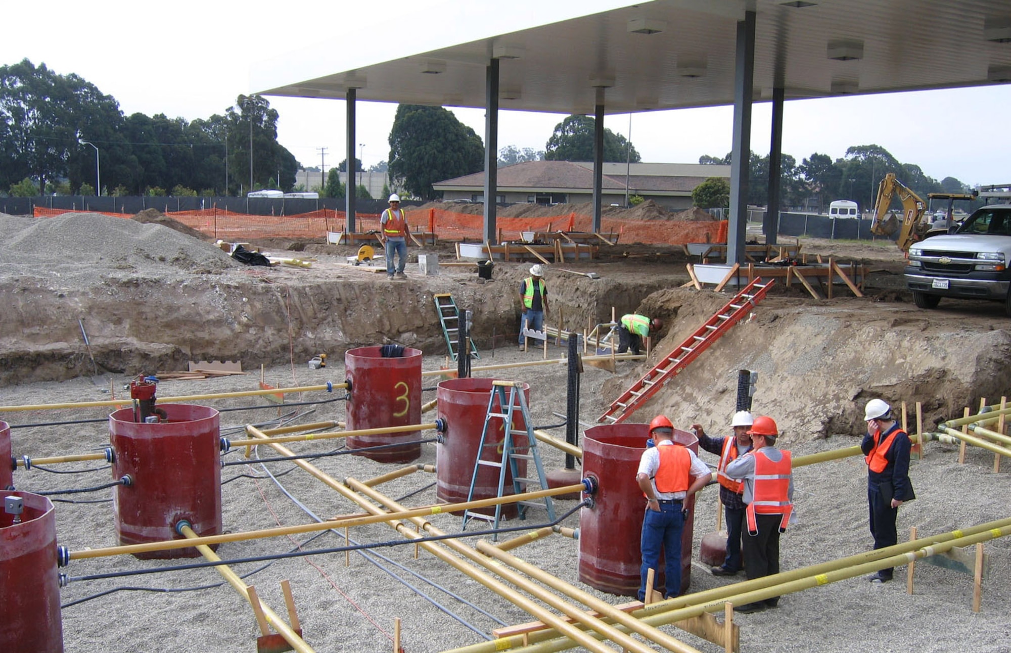 Government contractors discuss the progress of the newly constructed Army and Air Force Exchange Service fuel station at Vandenberg Air Force Base, Calif. This is the first of many projects that AFCEE has teamed with AAFES to construct. (Courtesy photo)