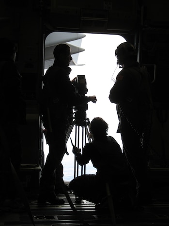 Members of the GSD&M Advertising film crew prepare to document a tactical descent from the troop door of a C-17 Globemaster III Feb 9.  Airmen from Charleston Air Force Base, S.C., will be featured in an Air Force advertising campaign set to air in March. (U.S. Air Force photo/Capt. Christopher Moore)