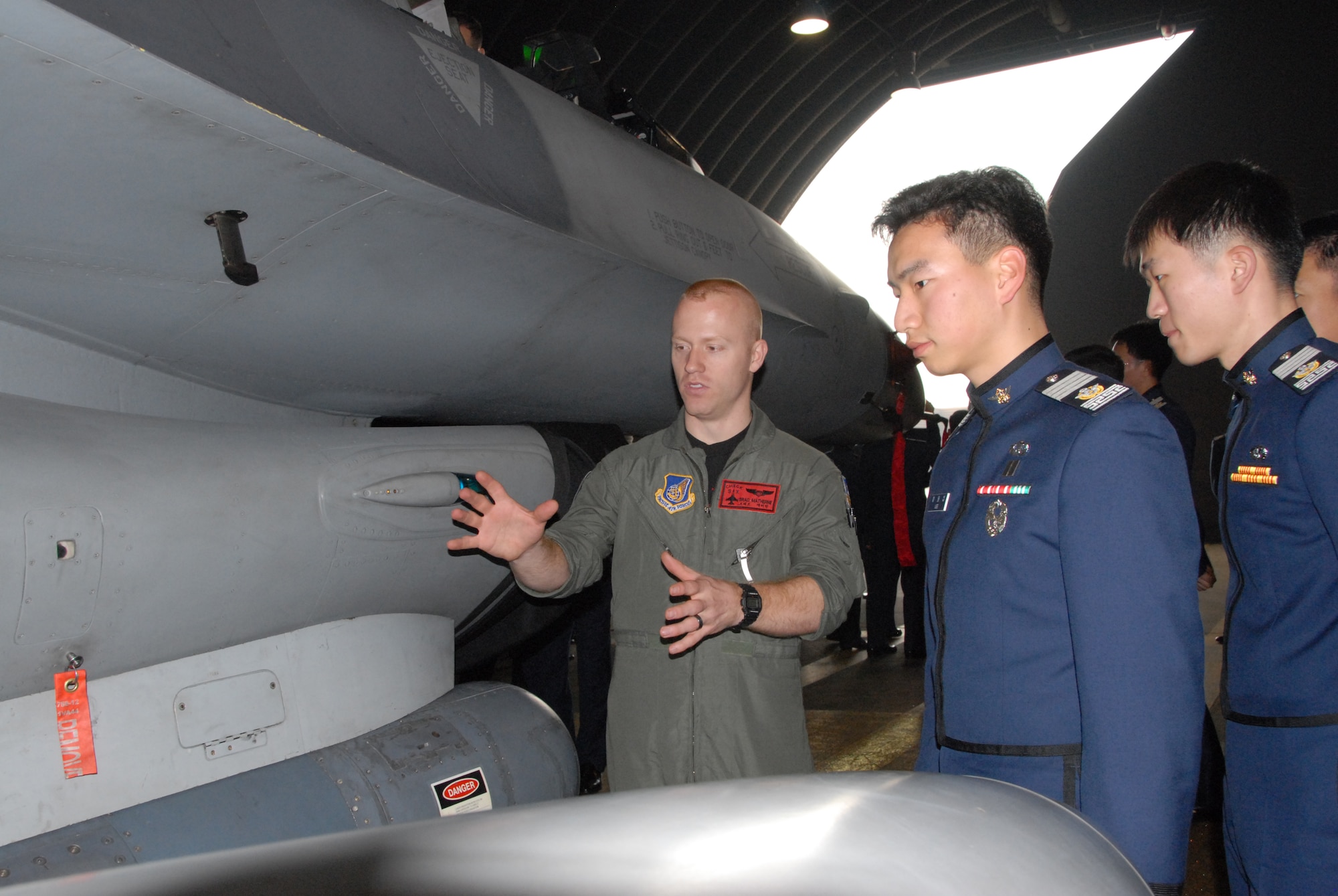 OSAN AIR BASE, Republic of Korea -- First Lt. Brad Matherne, a 36th Fighter Squadron pilot, talks to two cadets from the Republic of Korea Air Force Academy Wednesday. While they were visiting Osan, they saw the 5th Reconnaissance Squadron, 36th FS and 35th Air Defense Artillery patriot batteries. (U.S. Air Force photo by Senior Airman Eunique Stevens)