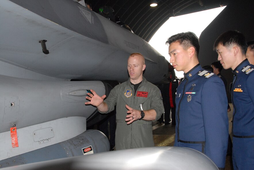 OSAN AIR BASE, Republic of Korea -- First Lt. Brad Matherne, a 36th Fighter Squadron pilot, talks to two cadets from the Republic of Korea Air Force Academy Wednesday. While they were visiting Osan, they saw the 5th Reconnaissance Squadron, 36th FS and 35th Air Defense Artillery patriot batteries. (U.S. Air Force photo by Senior Airman Eunique Stevens)