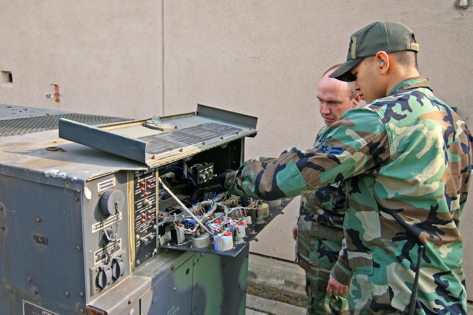 OSAN AIR BASE, Republic of Korea -- Tech. Sgt. Dennis Odom and Airman 1st Class Justin Tayamen, 51st Civil Engineer Squadron power production element, diagnose a generator. The 16-member power production element of the 51st Civil Engineer Squadron maintains and repairs more than 150 generators on Osan, as well as Aircraft Arresting Systems and Mobile Aircraft Arresting Systems. (U.S. Air Force photo by Master Sgt. Ben Huseman)