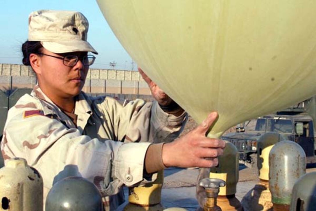 Spc. Kate Waters, a meteorological team crewmember assigned to the 1st