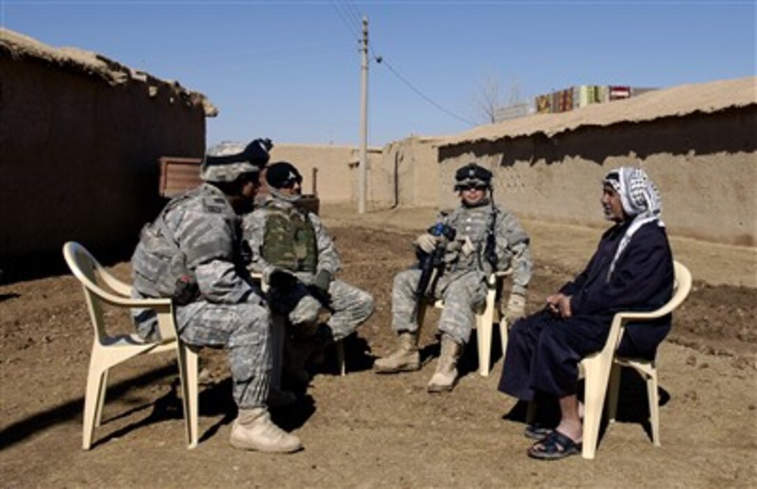 U.S. Army Sgt. 1st Class Christopher Noell, left, talks with the village elder during a foot patrol in Al Newafal, Iraq, Feb. 12, 2007. Noell is assigned to the 3rd Platoon, Alpha Company, 2nd Battalion, 35th Infantry Regiment, 25th Infantry Division deployed from Schofield Barracks, Hawaii.