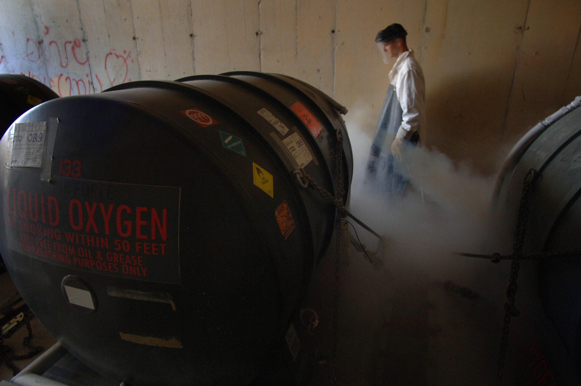 Staff Sgt. Gabriel Temples vents liquid oxygen tanks to prevent pressure buildup in storage containers. The liquid oxygen is used in aircraft that fly at high altitudes where there is not enough oxygen for the aircrew. Sergeant Temples is deployed to the 332nd Expeditionary Logistics Readiness Squadron from 5th Logistic Readiness Squadron, Minot Air Force Base, N.D. (U.S. Air Force photo/Staff Sgt. Michael R. Holzworth)