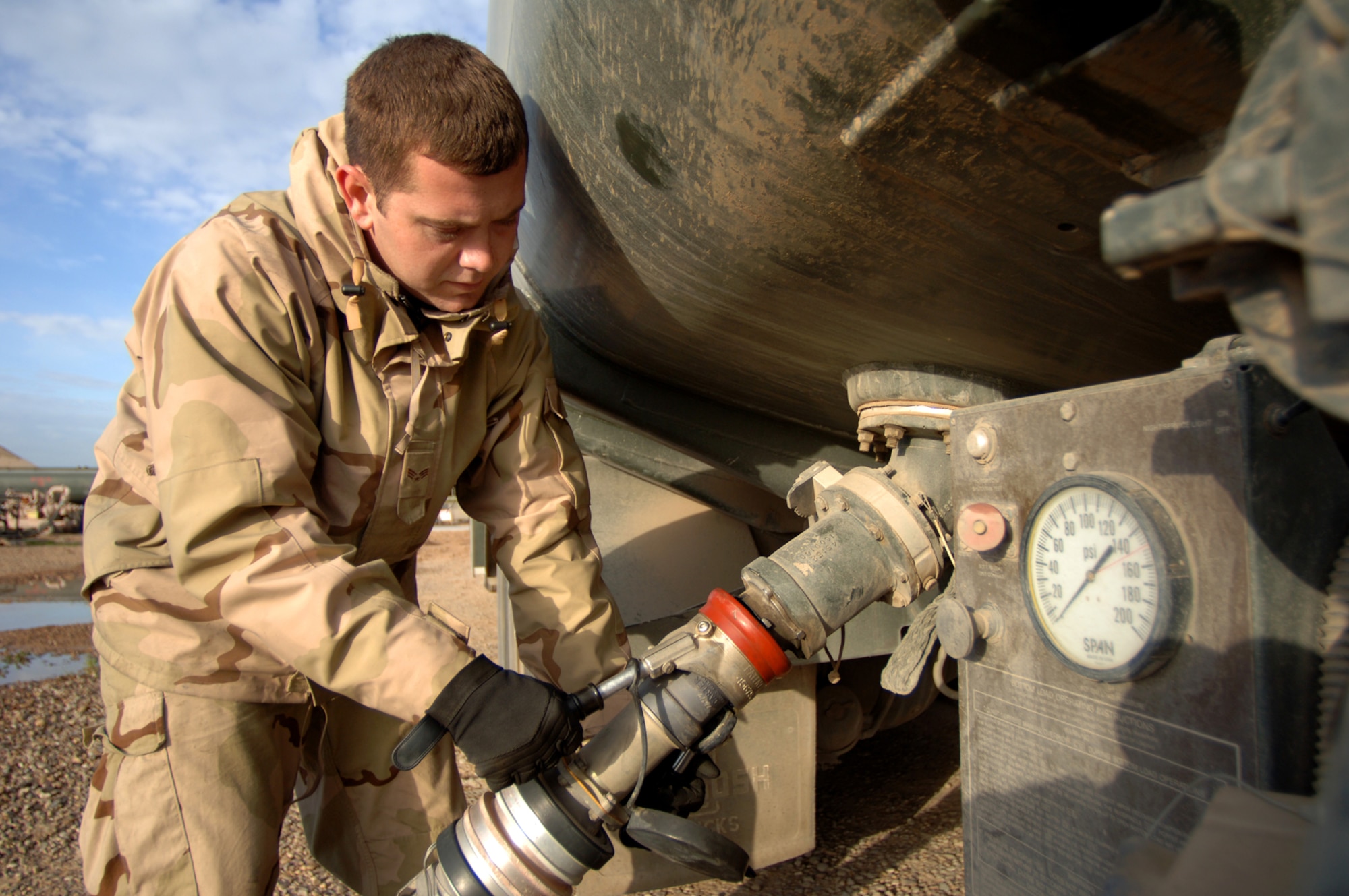 Senior Airman Gary Grammer disconnects the hose from an R-11 refueler Feb. 10 after filling it from a 210,000-gallon portable bladder at Balad Air Base, Iraq, , where he is responsible for refueling fixed wing aircraft and most rotary aircraft. The fuels flight has averaged dispensing 3.5 million gallons of JP-8 jet fuel each month over the last three months. Airman Grammer is deployed to the 332nd Expeditionary Logistics Readiness Squadron from the 436th Logistics Readiness Squadron, Dover Air Force Base, Del. (U.S. Air Force photo/Staff Sgt. Michael R. Holzworth)