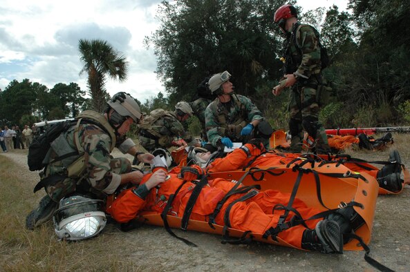 Air Force Reserve pararescuemen from the 920th Rescue Wing treat astronauts injured in a NASA orbiter crash during a Mode 7 Exercise at Cape Canaveral February 13th.  The exercise provided training in the event the Space Shuttle would veer off the runway during a landing into a remote area of Cape Canaveral.  NASA firefighters and Air Force Reserve pararescuemen were airlifted by rescue wing Pave Hawk helicopter aircrews to the remote site to exercise their egress and medical skills.