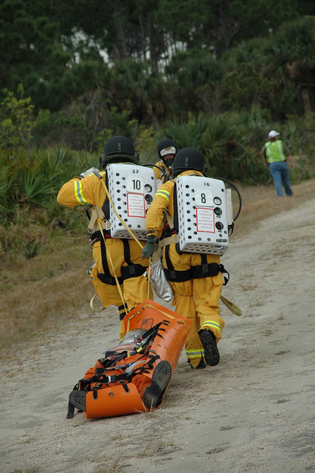 NASA firefighters shuttle astronauts to a triage area during a Mode 7 Exercise that took place at Cape Canaveral, Fla. February 13.  The exercise provides valuable egress training for emergency firefighters and the Air Force Reserve crews who support the shuttle in the event of an emergency.