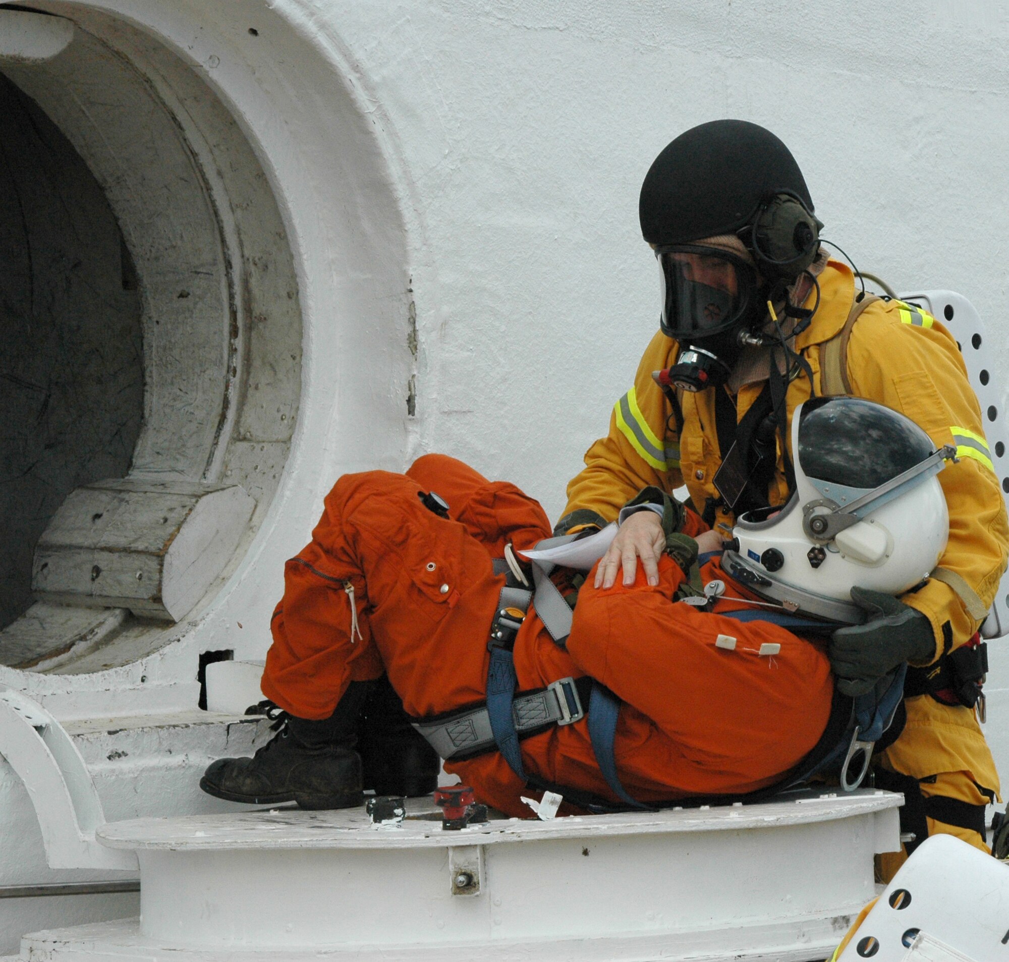 A NASA firefighter puts his astronaut egress training into effect during a simulated orbiter crash February 13 as part of a Mode 7 Exercise at Cape Canaveral, Fla. The exercise encompassed NASA, the 45 Space Wing and the Air Force Reserve's 920th Rescue Wing.