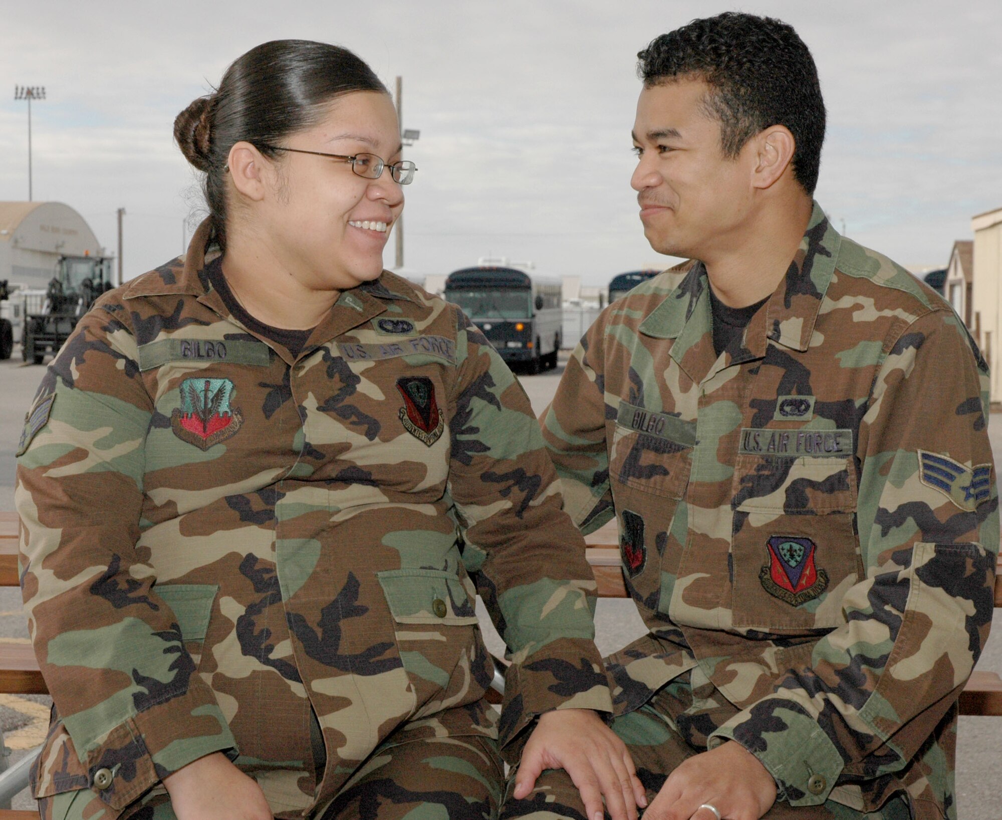 Senior Airmen Maria and Sherard Bilbo take a break from work to chat Feb. 14.  The two met on a whim while returning from a deployment in 2004 and are now married with a baby on the way.
