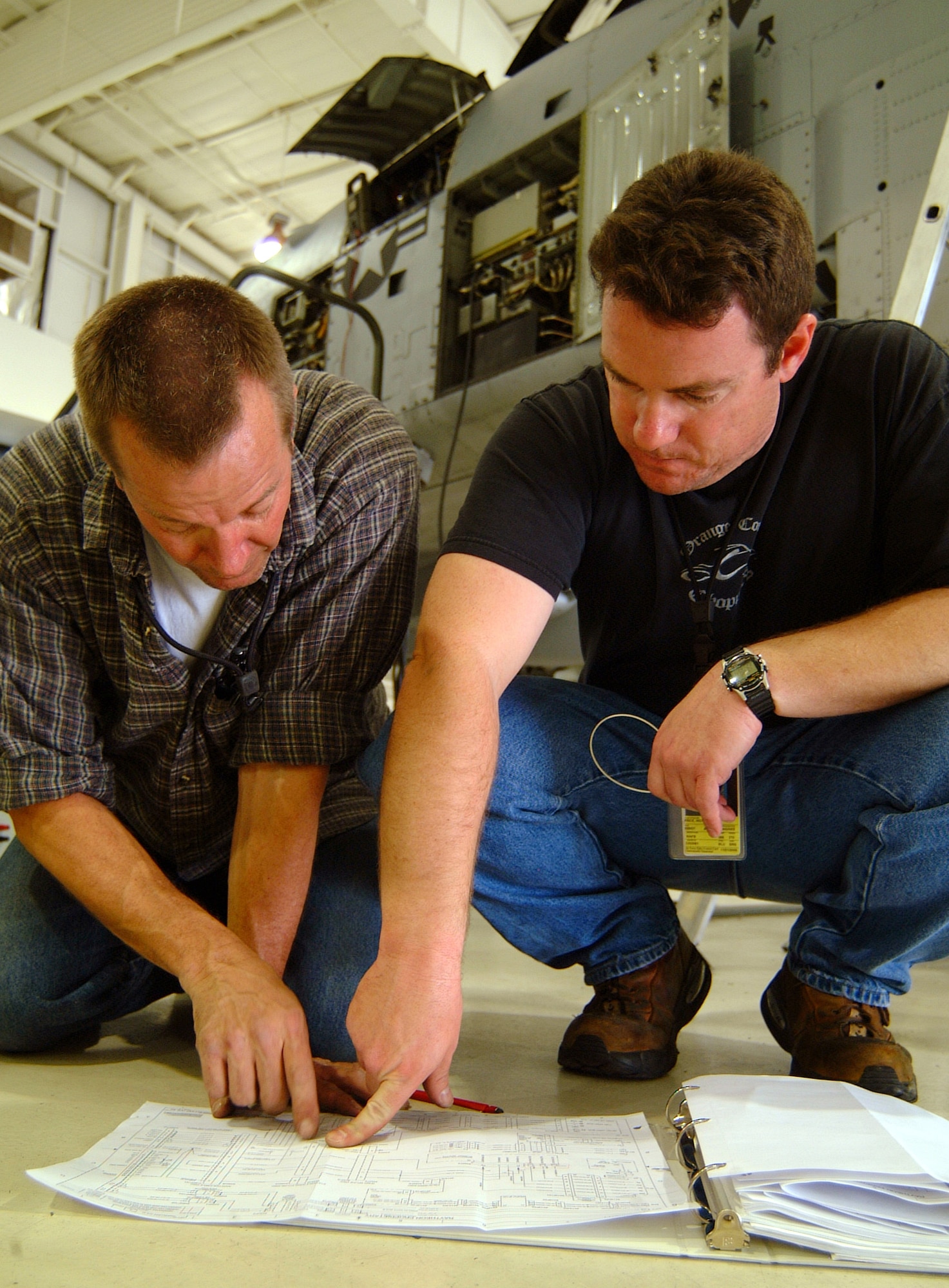 Air Reserve Technician Tech. Sgts. Paul Hanson (left) and Mike Price consult a wiring diagram while testing a newly-installed "smart" multi-function color display system on an A-10 Thunderbolt II from the 442nd Fighter Wing at Whiteman Air Force Base, Mo.  The two sergeants are avionics specialists with the 442nd Aircraft Maintenance Squadron.  (U.S. Air Force photo/Maj. David Kurle)