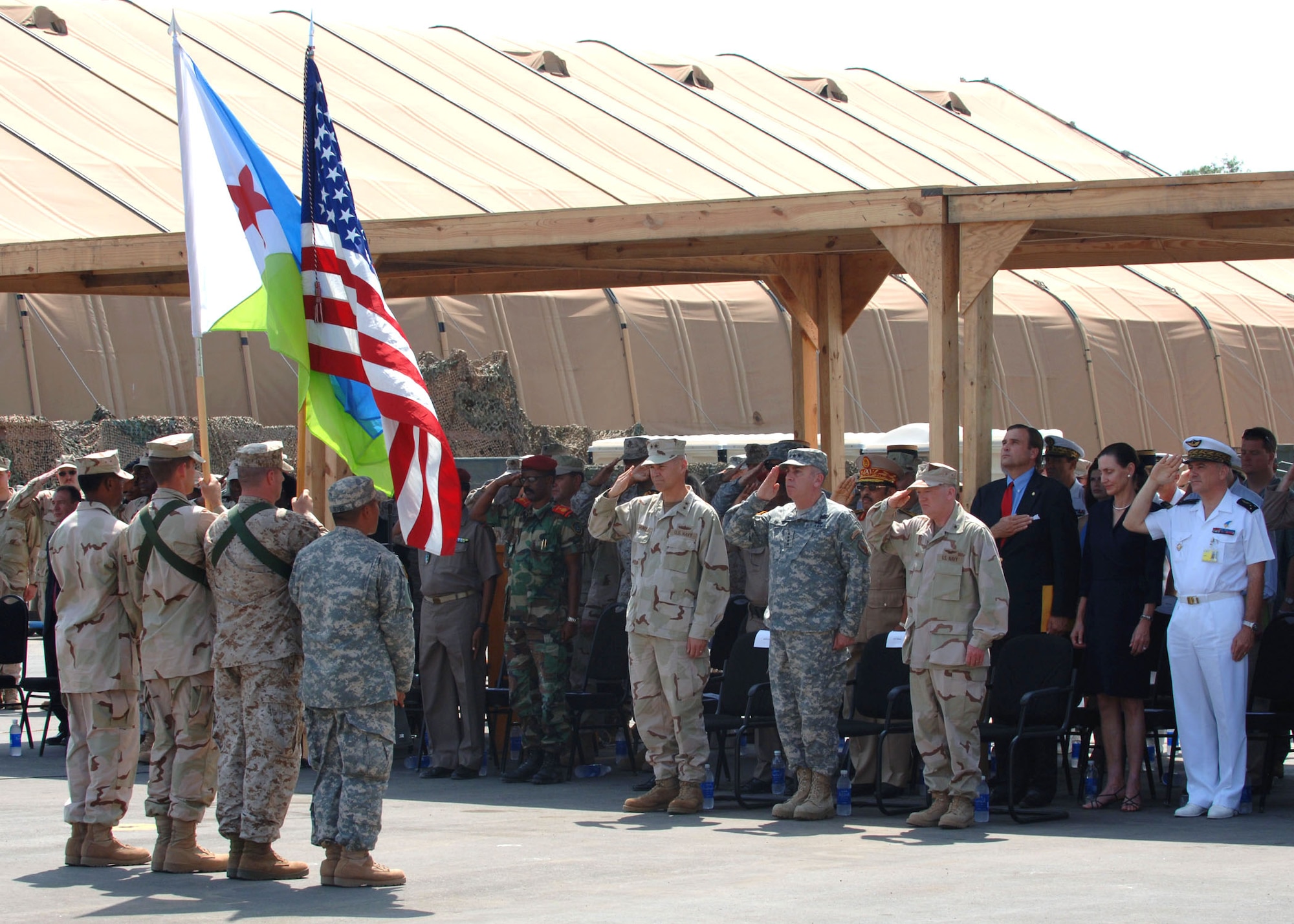 Rear Adm. Richard Hunt (from left), Army Gen. John Abizaid and Rear Adm. James Hart salute the colors during the Combined Joint Task Force - Horn of Africa change-of-command ceremony Feb. 14 at Camp Lemonier, Djibouti.  General Abizaid officiated as Admiral Hunt passed command of the task force to Admiral Hart.  (U.S. Air Force photo/Tech. Sgt. Carrie Bernard)