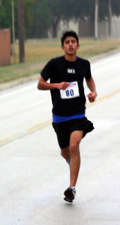LAUGHLIN AIR FORCE BASE, Texas -- Jonathan Morales, 2nd place winner in Bracket 1 of the Valentine 5K run/walk Feb. 10, finishes the run in 19 minutes, 49 seconds.  Chui Ordaz, 1st place winner of this bracket with a time of 19 minutes, 31 seconds, and Jonathan Morales are two participants from the local high school.  The event was organized by the Losano Fitness Center and was open to everyone.   (U.S. Air Force photo by Senior Airman Olufemi Owolabi)