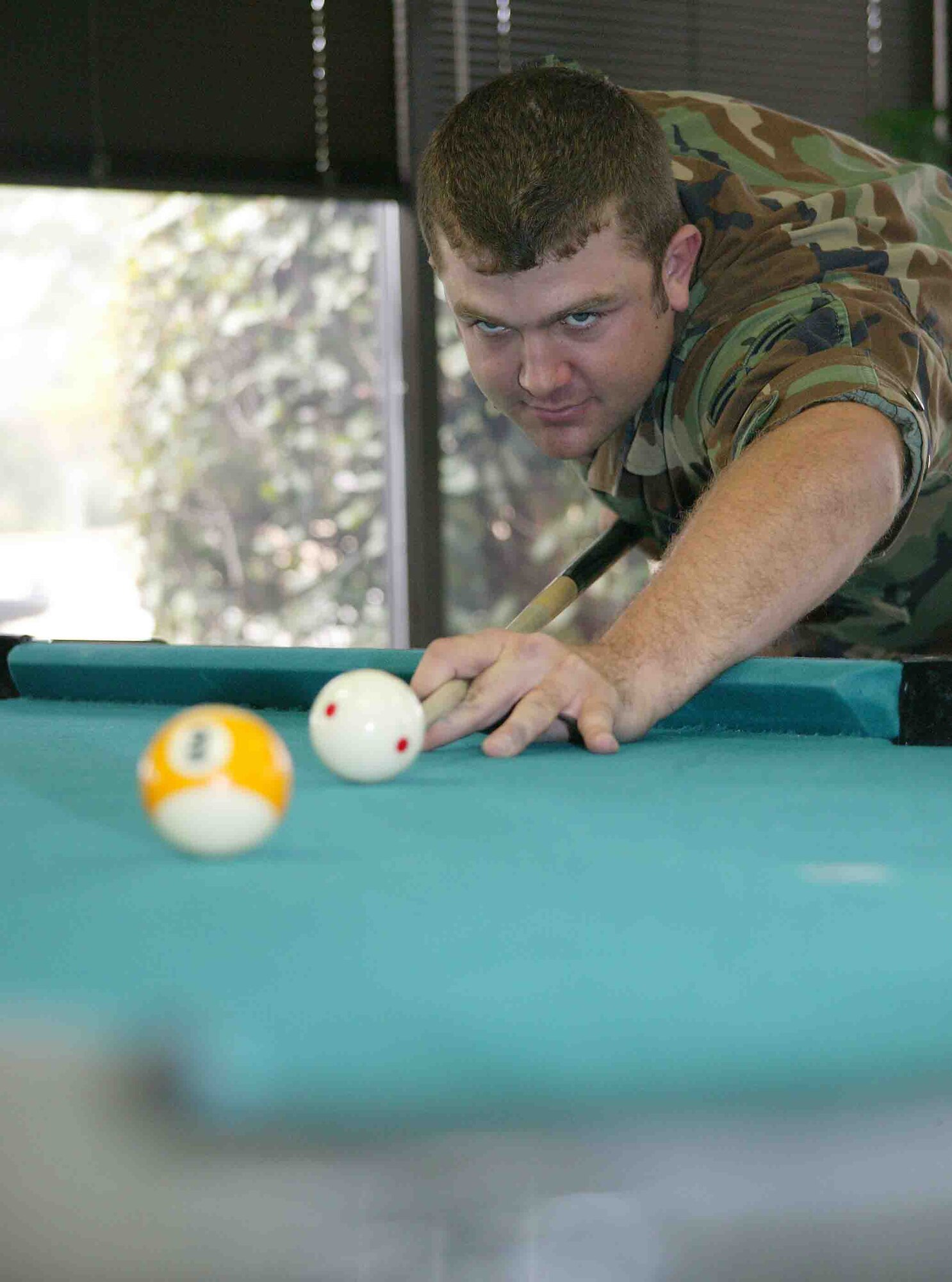 SHAW AIR FORCE BASE, S.C. -- Senior Airman Eric Charlton, 20th Civil Engineer Squadron explosives ordnance disposal technician, shoots a round of nine ball Feb. 12 with a co-worker at the community center. Airman Charlton is competing in the National 9-Ball Bar-Table Championship from Feb. 28 to March 2 in Reno, Nev. (U.S. Air Force photo/Senior Airman John Gordinier)