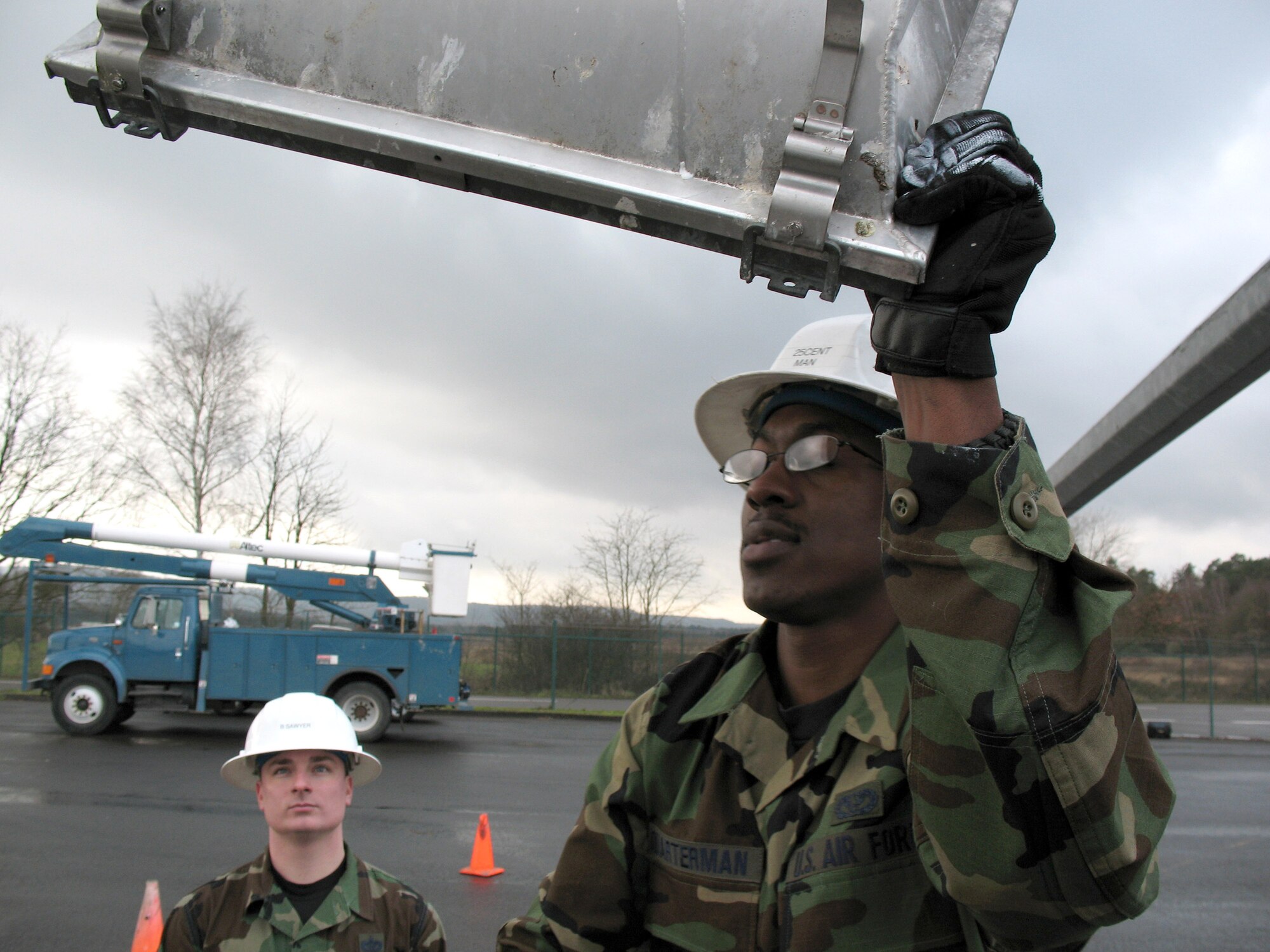 Civil engineers at Ramstein Air Base, Germany, lower an 80-foot light pole on the flightline Feb. 13 to repair non-working lights.  (U.S. Air Force photo/Airman 1st Class Mara Title)