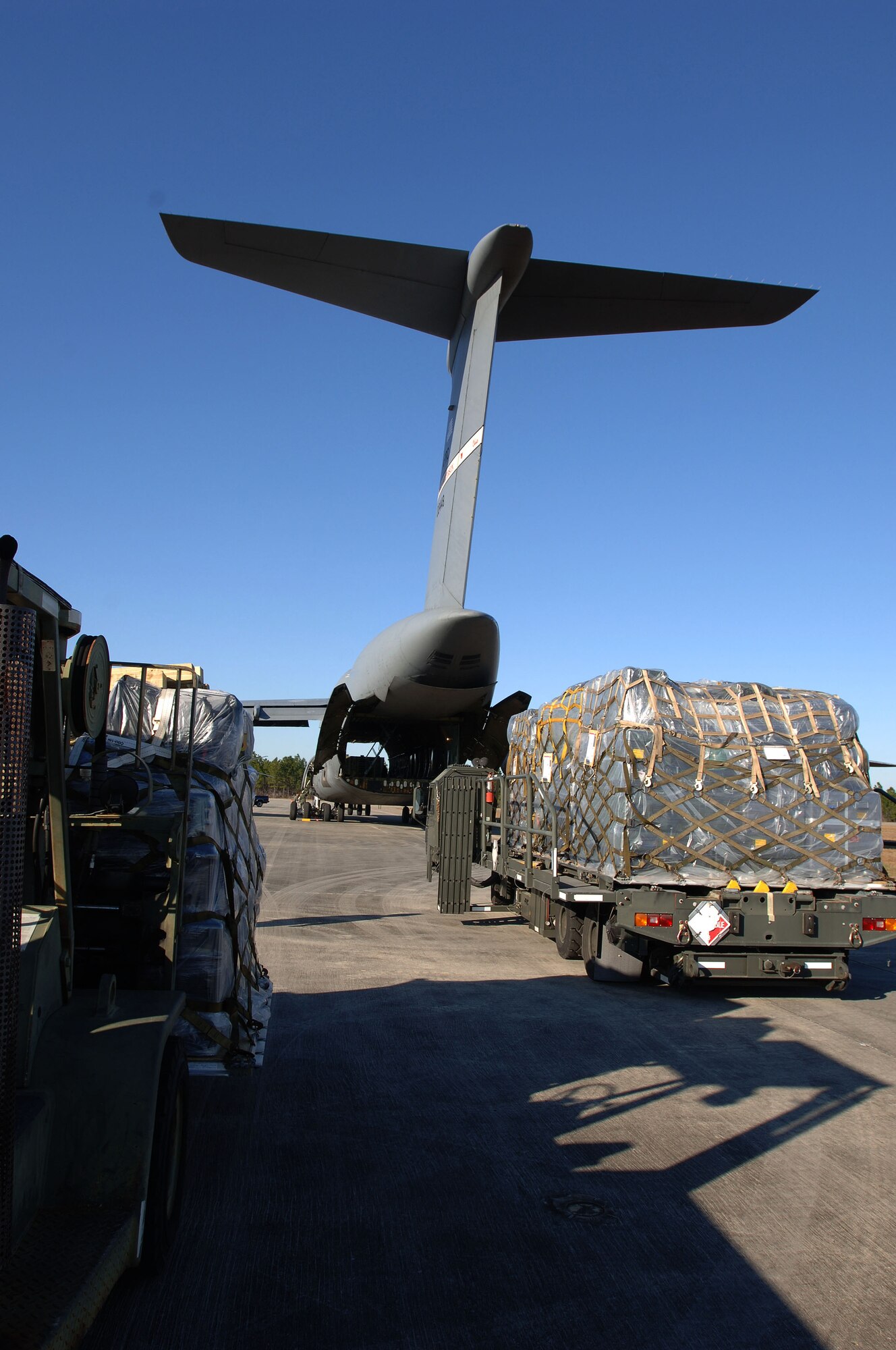 A truck loaded with deployable command and control components remains on stand-by for loading aboard a C-5 aircraft provided by the U.S. Transportation Command. NSWC PC personnel joined with Tyndall personnel Jan. 25-28 to load the DJC2 system aboard aircraft for delivery to the U.S. European Command.

