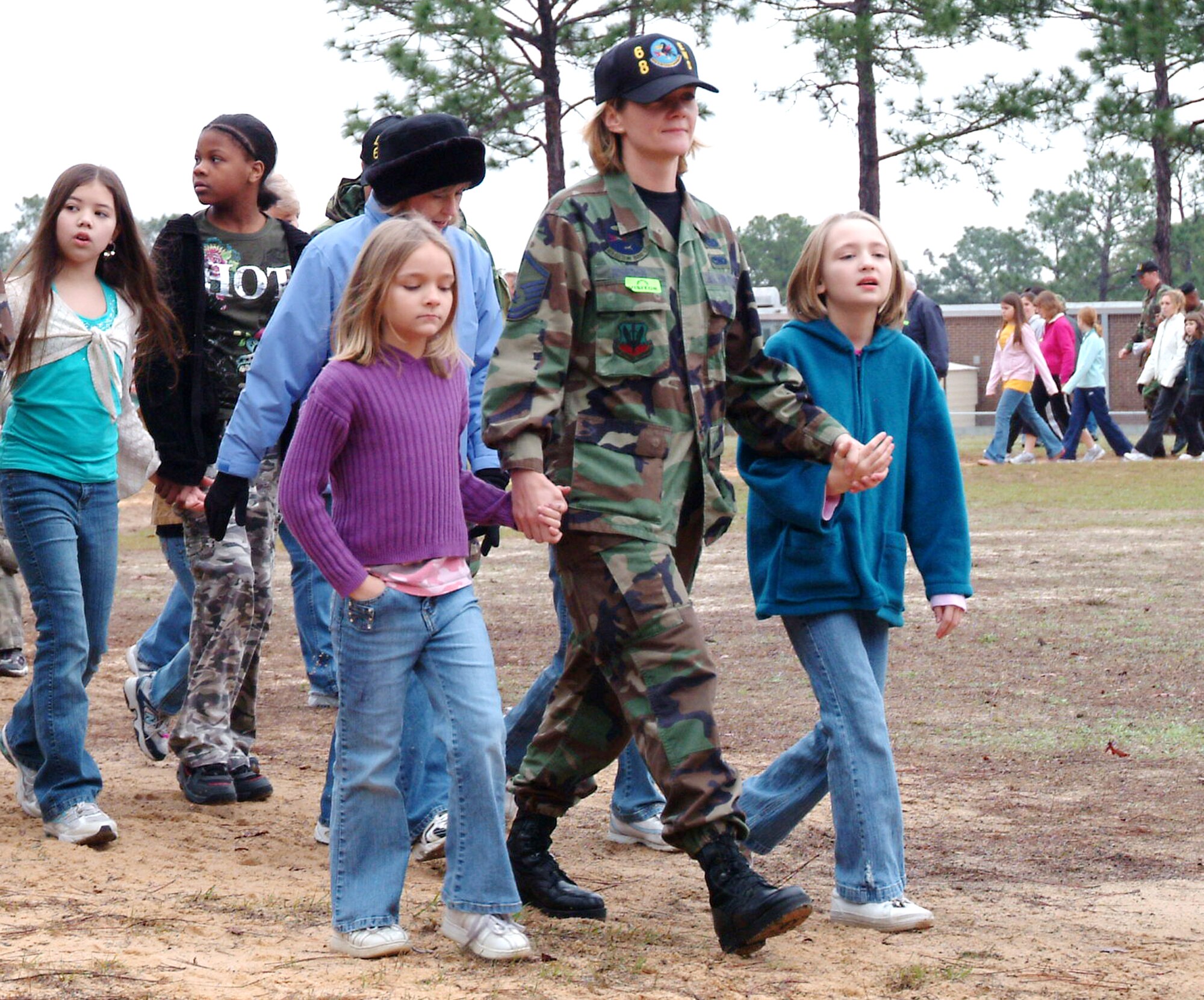 EGLIN AFB, Fla -- Master Sgt. Stefanie Riseden, 68th Electronic Warfare Squadron, walks with her girls Sarah (left) and Angela (right) during Longwood Elementary’s “Step Up” walkathon Feb. 2 in Shalimar, Fla.  More than 20 members of the 53d Wing and other Eglin units participated in the Florida program which encourages fitness and health awareness. (U.S. Air Force photo by Staff Sgt. Samuel King Jr.)