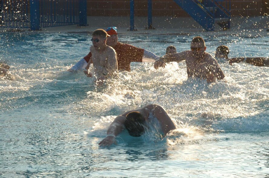 Dyess members forge across freezing-cold water in the base pool during the Polar Bear Plunge Feb. 13. (U.S. Air Force photo by Airman 1st Class Carolyn Viss)                               