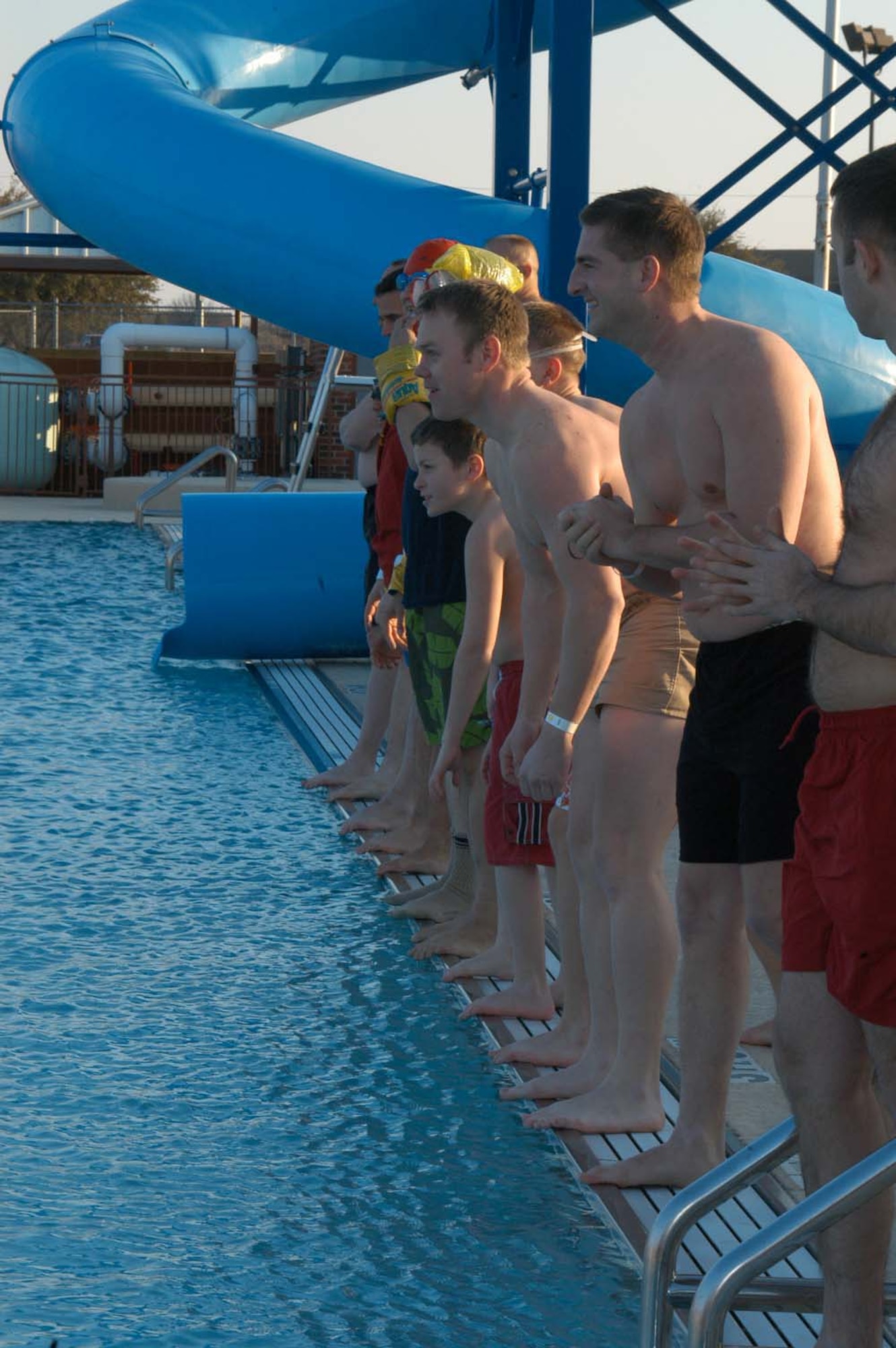 Members of Team Dyess and their families step to the edge of the base pool for the countdown to the Polar Bear Plunge Feb. 13. The event took place in freezing temperatures and wind. (U.S. Air Force photo by Airman 1st Class Carolyn Viss)                                                               