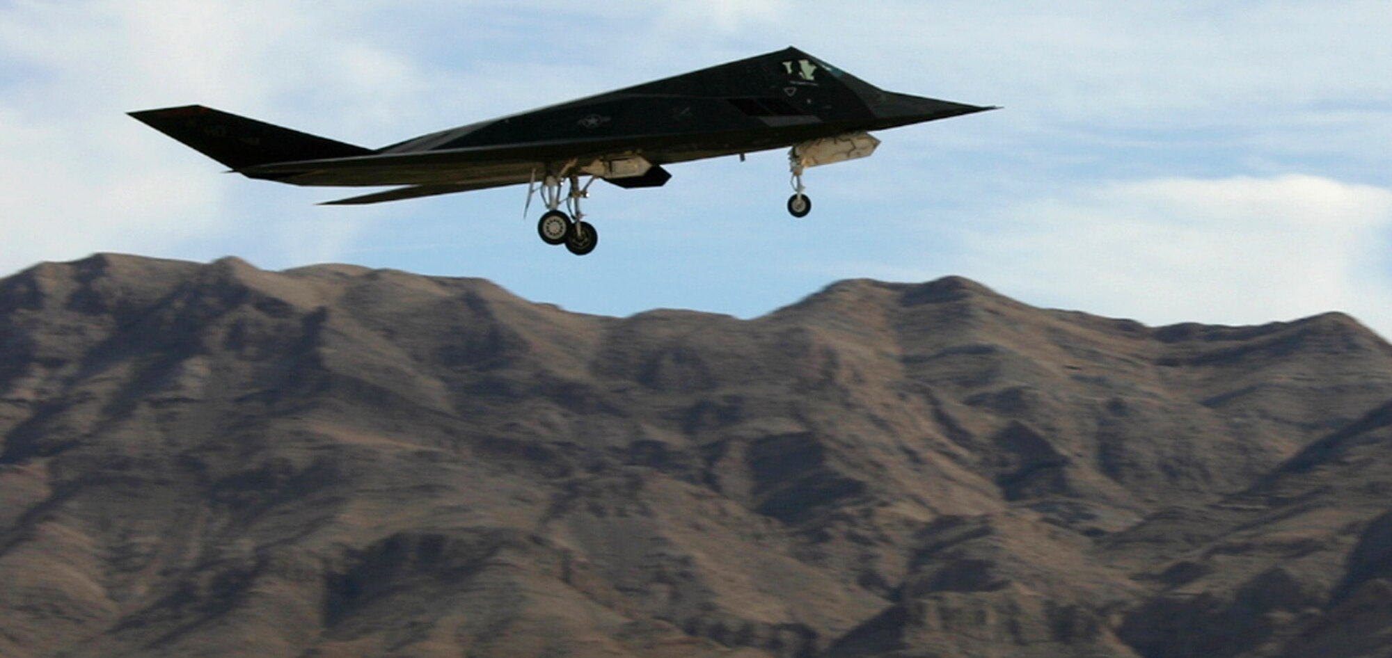 An F-117 Nighthawk lands after a Red Flag mission Feb. 12 at Nellis Air Force Base, Nev. All three of the Air Force's stealth aircraft models -- the B-2 Spirit, F-117 and F-22 Raptor -- are taking part in Red Flag, which sharpens aircrews' warfighting skills in realistic combat situations. Crews are flying missions during the day and night to the nearby Nevada Test and Training Range where they take part in highly realistic aerial combat. The Air Force and Navy, along with Australia and the United Kingdom militaries, are participating in this Red Flag. (U.S. Air Force photo/Mike Estrada)