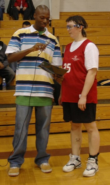 MINOT, N.D. – Staff Sgt. Kevin Grimes (center), 91st Missile Security Forces Squadron, Minot Air Force Base, N.D., recites the Special Olympics Pledge with an athlete before the Minot Special Olympics district basketball tournament at Bishop Ryan High School Feb. 10. The pledge is "Let me win. But if I cannot win, let me be brave in the attempt." Sergeant Grimes and almost 20 other members from the base community provided all the volunteer support for the tournament. (U.S. Air Force photo by Maj. Elizabeth Ortiz)