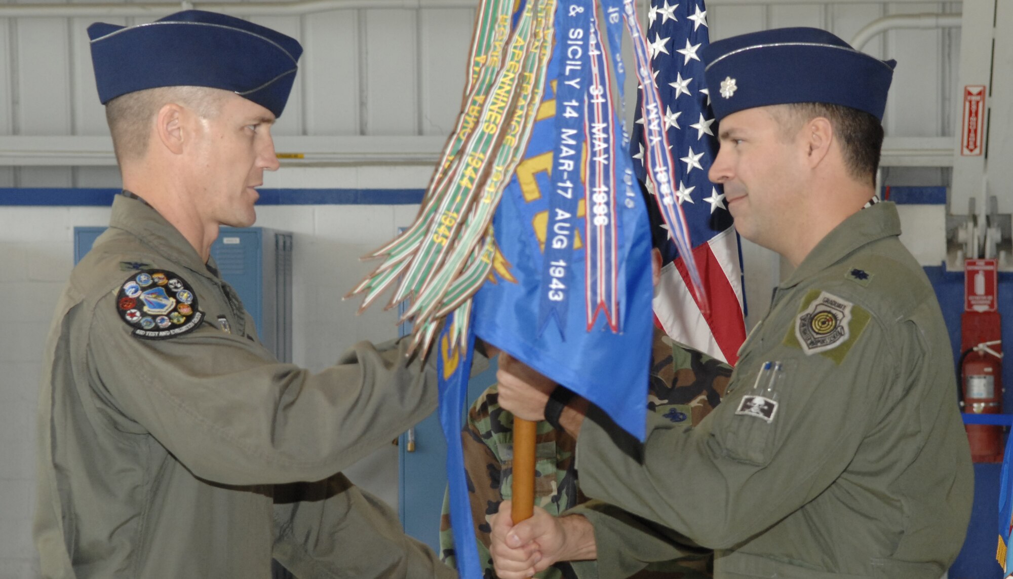 EGLIN AFB, Fla -- Lt. Col. Sam Shaneyfelt accepts the 85th Test and Evaluation Squadron guidon from Col. Greg Neubeck, 53d Test and Evaluation Group commander, during a change of command ceremony Jan. 31. Colonel Shaneyfelt takes over the 85th TES from Lt. Col. J. Todd Hicks.  He previously served as the director of operations for the squadron, which is responsible for operational testing and evaluation, tactics development, and evaluation programs for the F-15C, F-15E and F-16C aircraft. (U.S. Air Force photo)