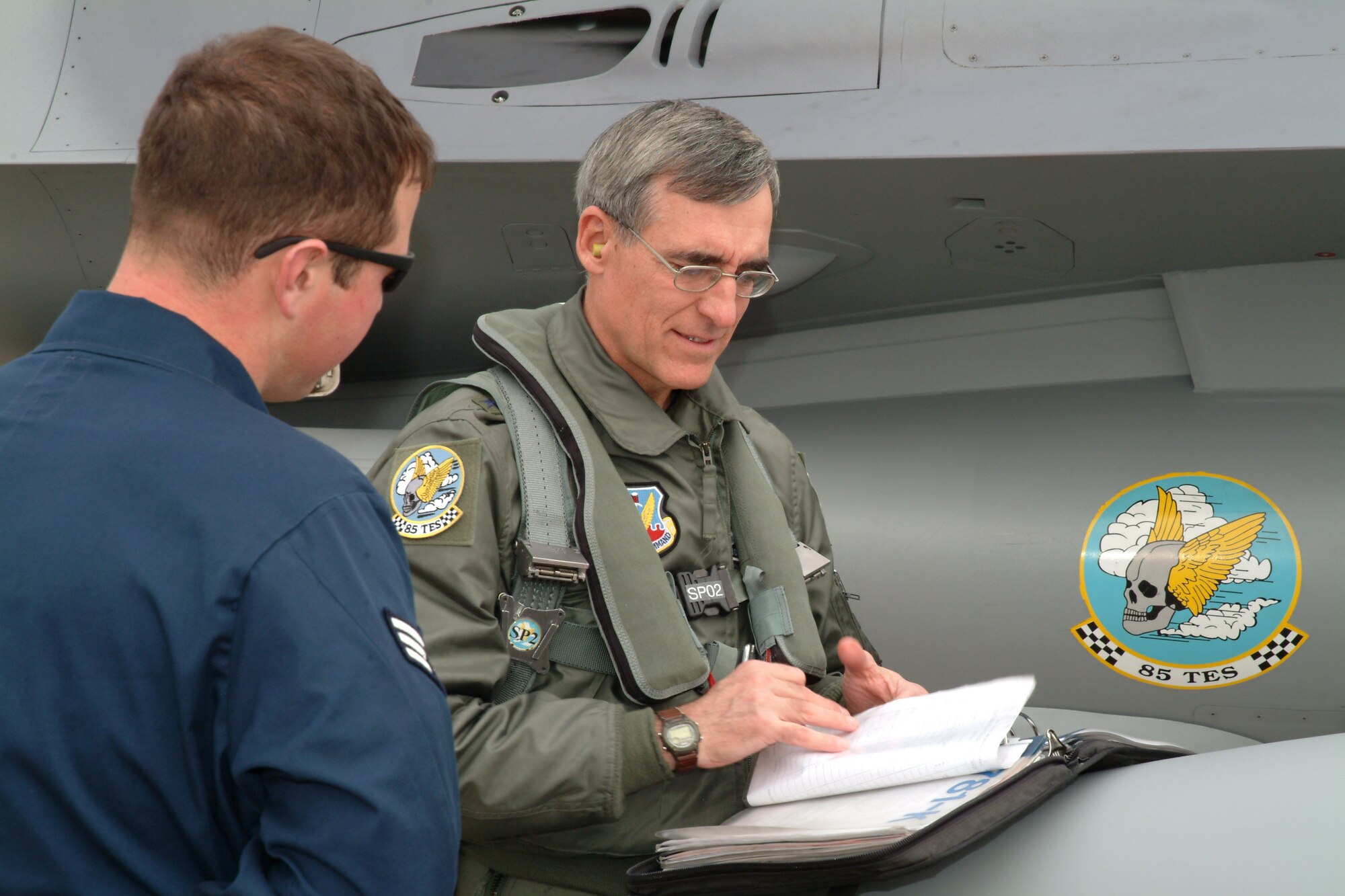 EGLIN AFB, Fla. -- Maj. Gen. Mike Worden, U.S. Air Force Warfare Center commander, goes over aircraft maintenance forms with Senior Airman Robert Barger, 46th Aircraft Maintenance Squadron F-16 crew chief, before his flight Jan 30. It was the general's first F-16 flight over Eglin’s Range. The general visited the 53d Wing and other local units who report directly to USAFWC, during a routine Gulf Coast visit. (U.S. Air Force photo by Tech. Sgt. Andrew Leonhard)