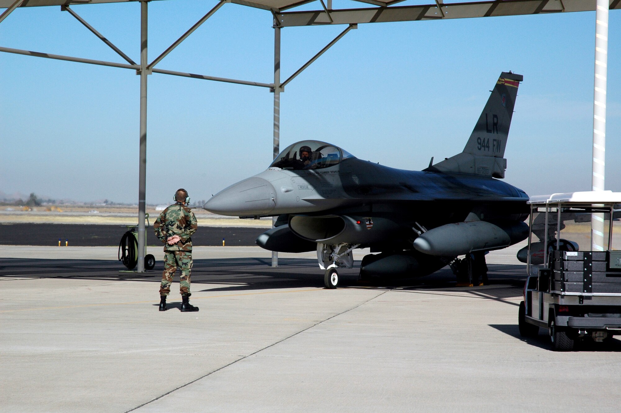 Master Sgt. Bob Rydzynski marshals an F-16 Fighting Falcon for its historic last flight Feb. 12 from Luke Air Force Base, Ariz. The last three F-16s assigned to the 944th Fighter Wing departed Luke as part of Base Realignment and Closure Commission actions. Sergeant Rydzynski is a crew chief at the 944th Aircraft Maintenance Squadron. (U.S. Air Force photo/Staff Sgt. Susan Stout)