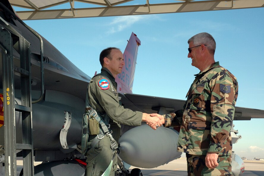 Lt. Col. Donald Lindberg shakes the hand of his crew chief, Tech. Sgt. Dan Dennison, Feb. 12 before taking his final flight in a 944th Fighter Wing F-16 Fighting Falcon. The last three F-16s assigned to the wing departed Luke Air Force Base, Ariz., as part of Base Realignment and Closure Commission actions. Colonel Lindberg is the 302nd Fighter Squadron commander. (U.S. Air Force photo/Staff Sgt. Susan Stout)